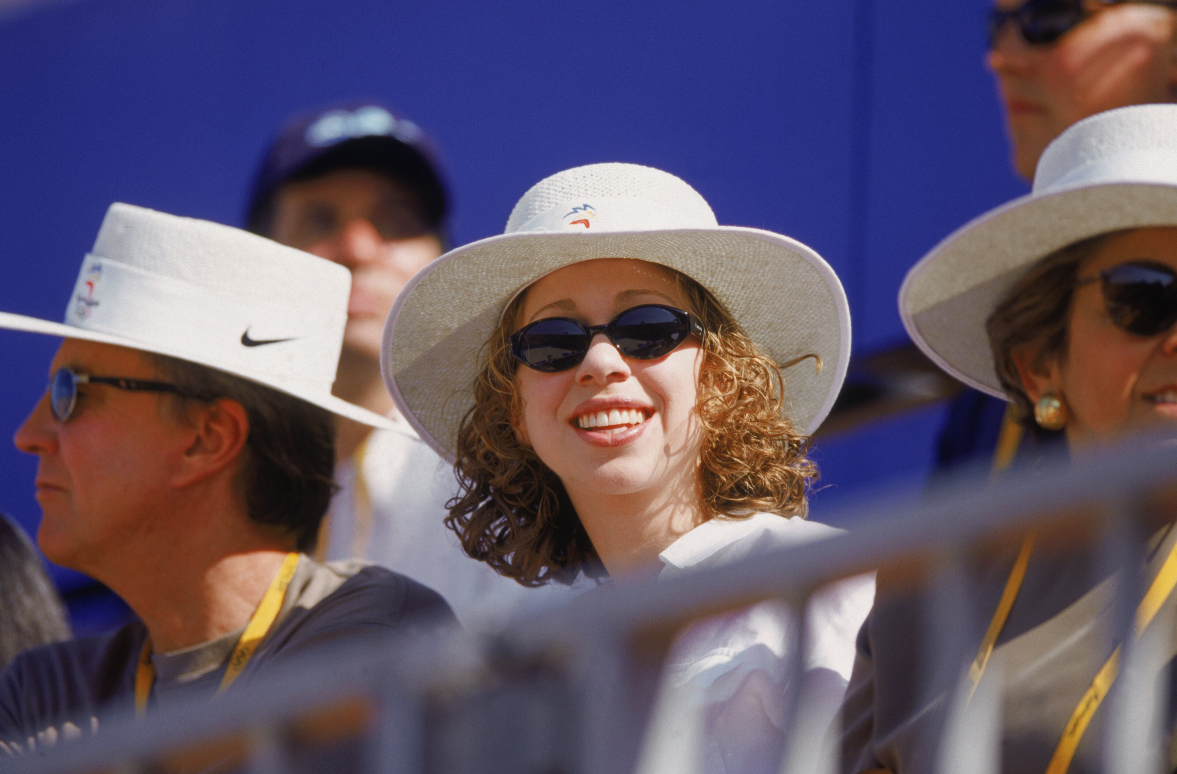 Chelsea Clinton smiles from the stands during the Olympic Women's Beach Volleyball competition at Bondi Beach in Sydney, Australia on September 18, 2000. (Photo by Robert Cianflone/Getty Images)