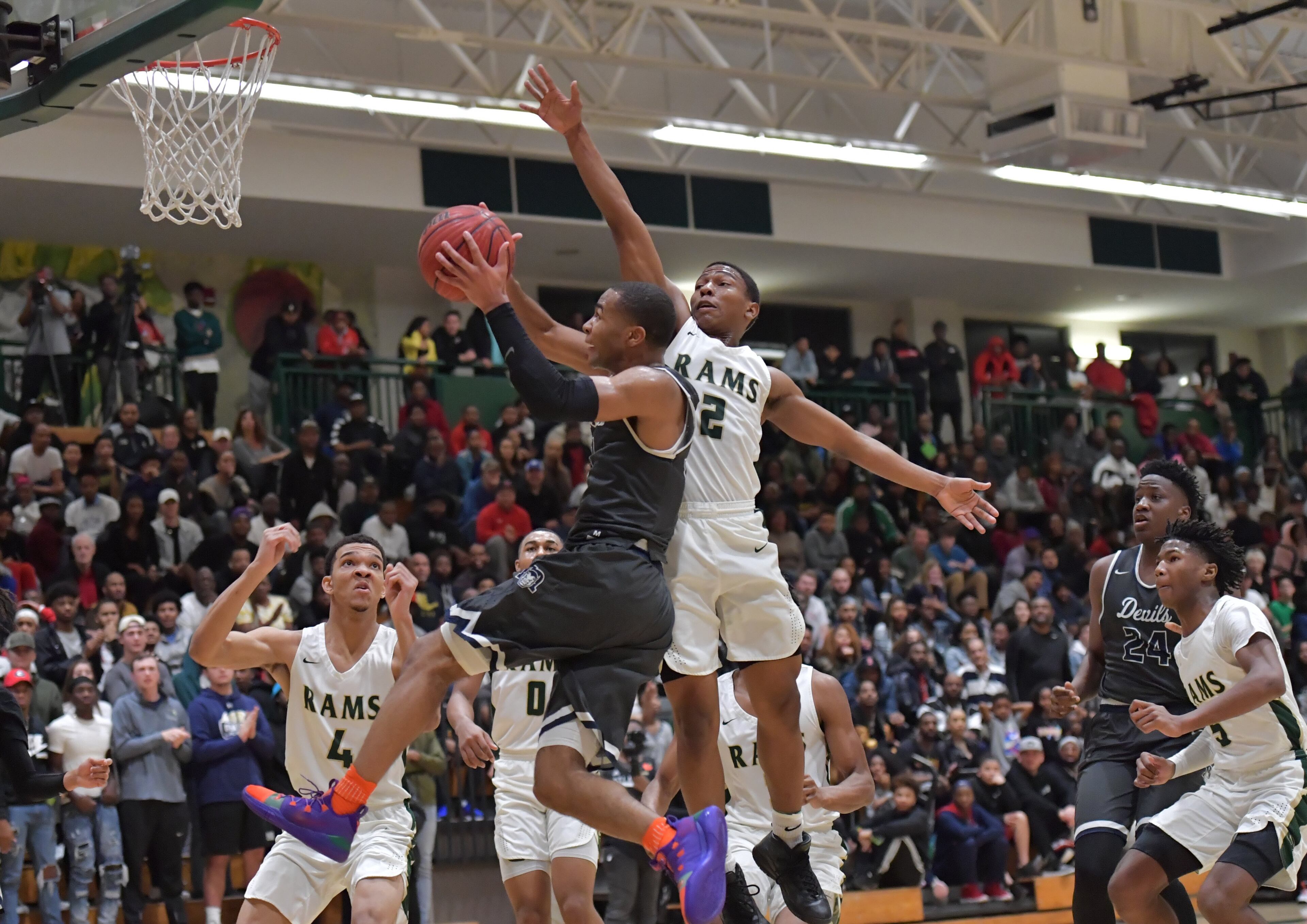 Norcross' Kyle Sturdivant (3) goes to the basket past Grayson's Jevon Tatum (2). (Hyosub Shin/hshin@ajc.com)