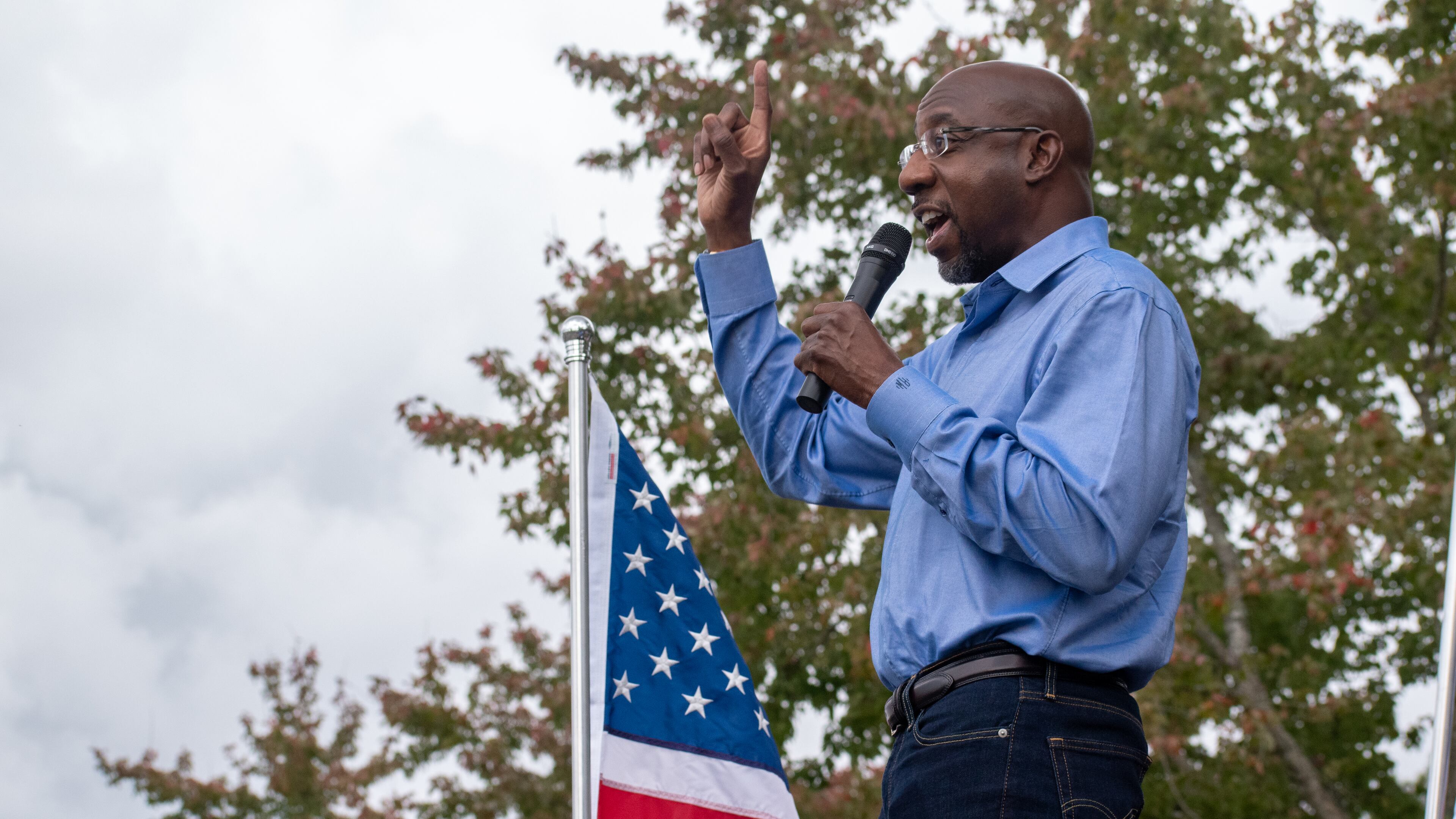 Democrat Raphael Warnock addresses a crowd at a Gwinnett County rally on Oct. 24, 2020. (OLIVIA HAYDEN / AJC)
