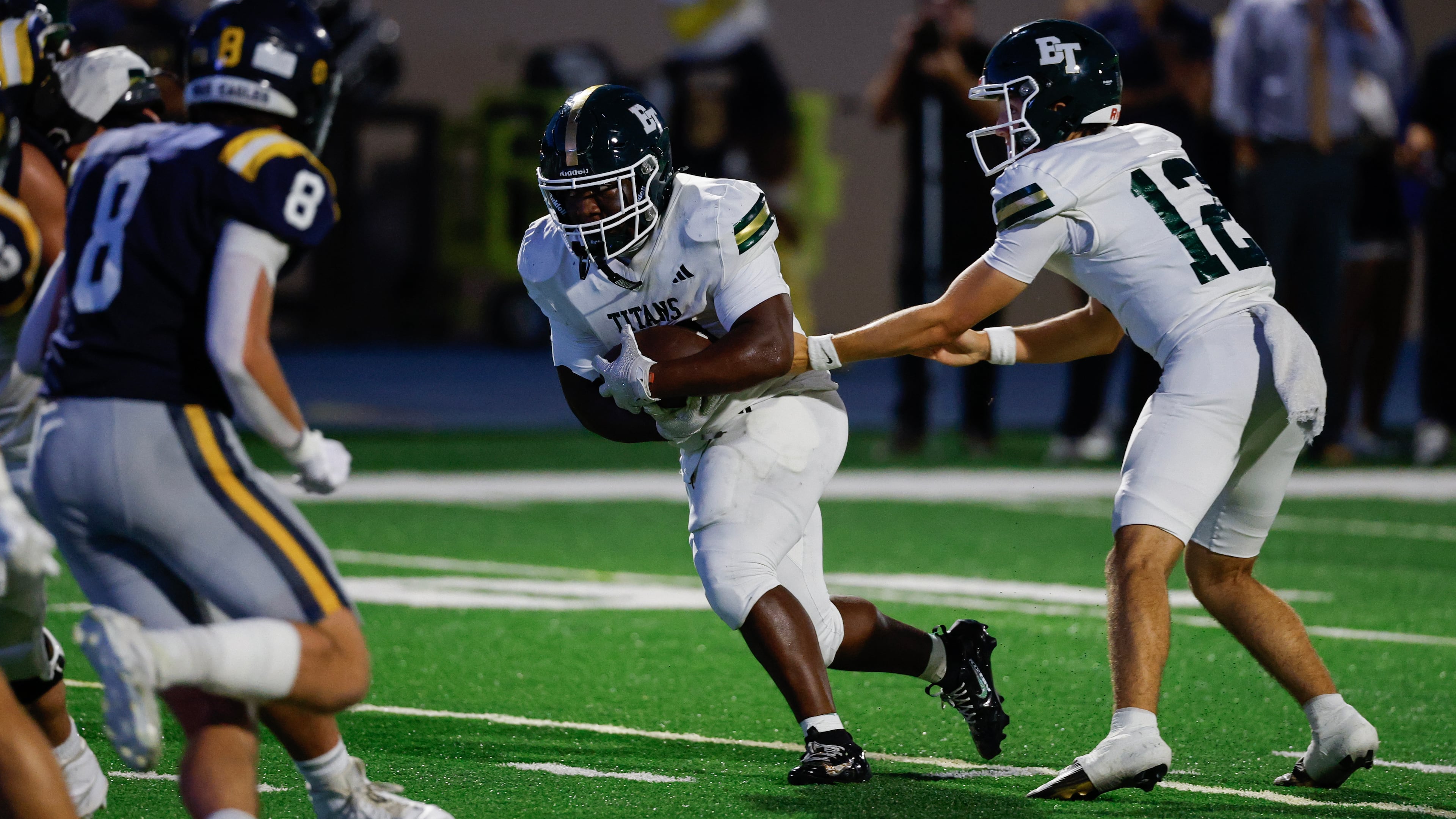 Blessed Trinity running back MJ Craft (34) takes a handoff for a touchdown from quarterback Luke Ray (12) during the first half a high school football game between Blessed Trinity and Marist, Friday, Sept. 25, 2026, in Atlanta. (Erik S. Lesser for the AJC)