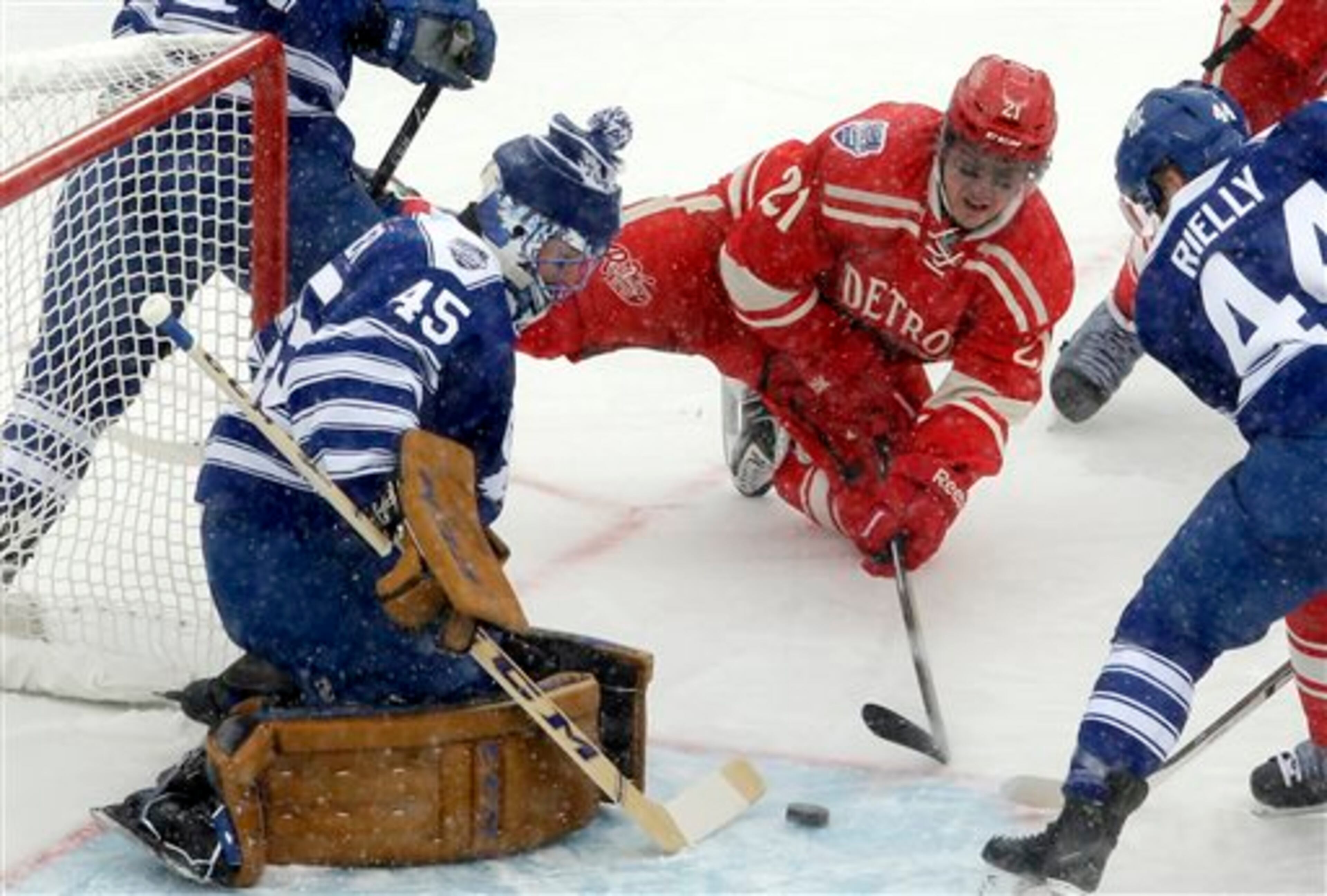 Toronto Maple Leafs goalie Jonathan Bernier (45) blocks a shot by Detroit Red Wings left wing Tomas Tatar (21), of the Czech Republic, during the first period of the Winter Classic outdoor NHL hockey game at Michigan Stadium in Ann Arbor, Mich., Wednesday, Jan. 1, 2014. (AP Photo/Carlos Osorio)