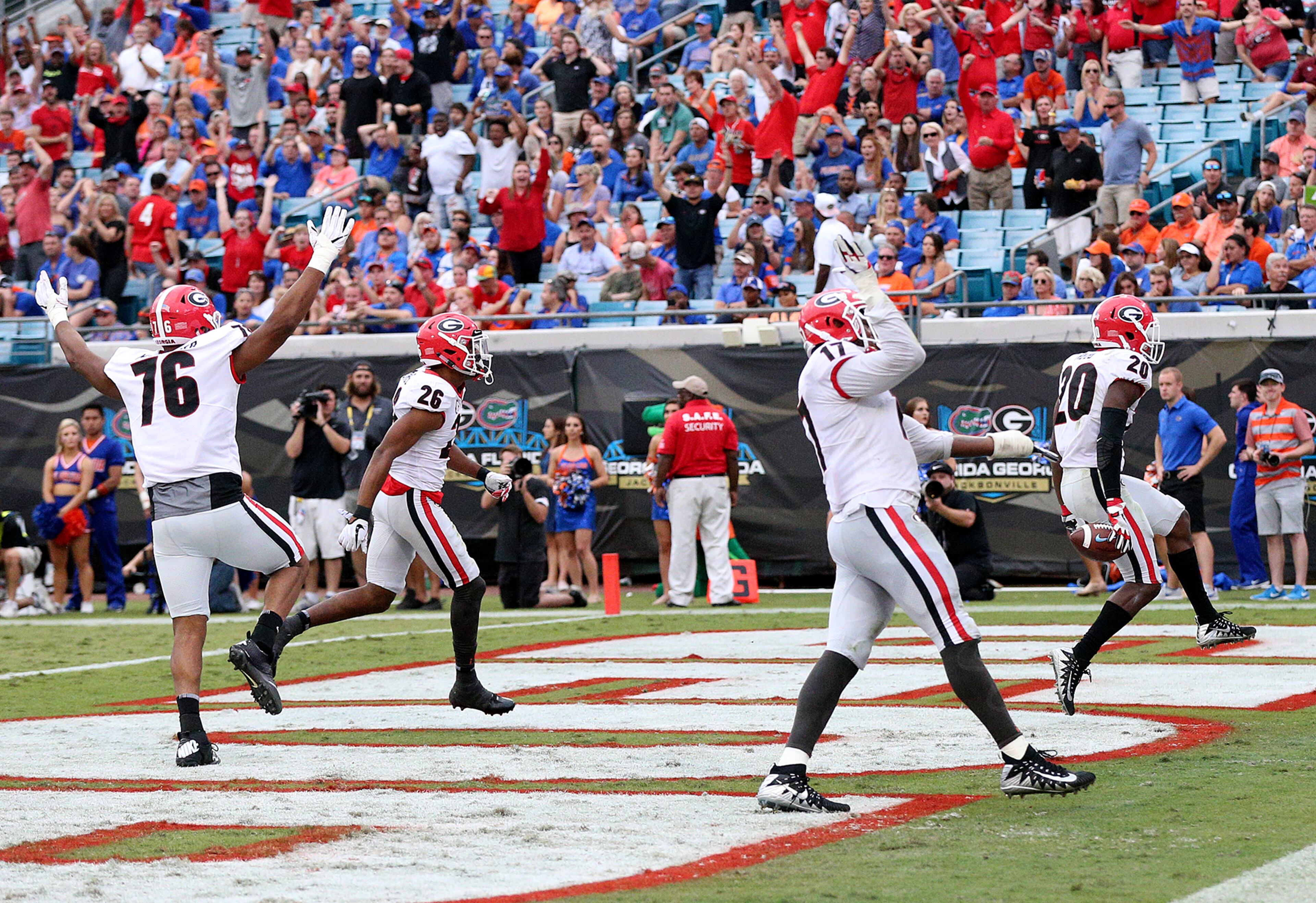 October 28, 2017 Jacksonville: After Georgia defensive back Tyrique McGhee sacked Florida quarterback Feleipe Franks forcing the fumble, J.R. Reed (far right) returns it for the score for a 35-0 lead during the third quarter in the Georgia-Florida NCAA college football game on Friday, October 27, 2017, in Jacksonville. Georgia beat Florida 42-7. Curtis Compton/ccompton@ajc.com