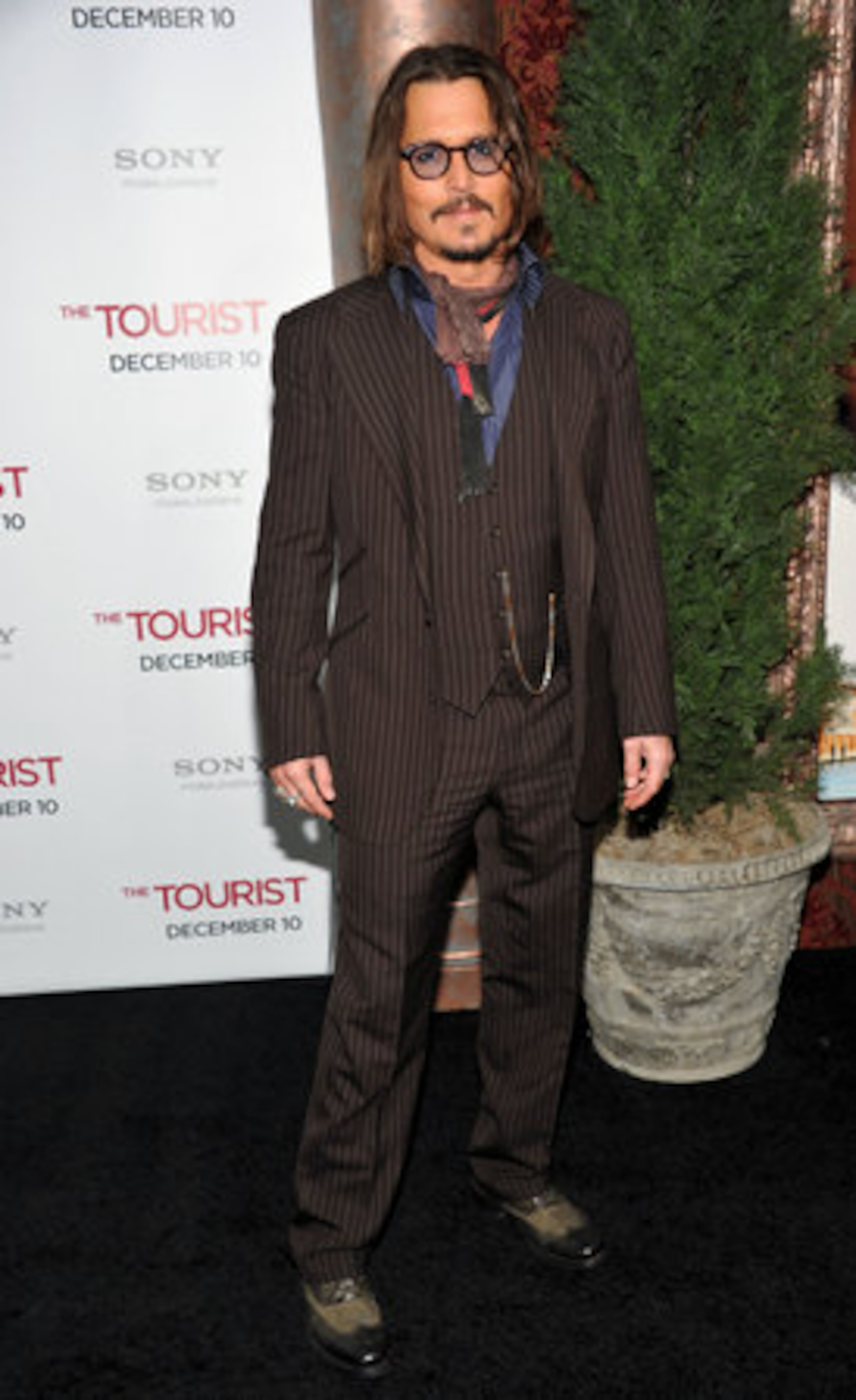 Actor Johnny Depp, dressed to the nines in a pinstripe ensemble, attends the world premiere of "The Tourist" at the Ziegfeld Theatre. Depp plays Frank, an American tourist visiting Italy to mend a broken heart who runs into trouble after crossing paths with Elise, played by Angelina Jolie.