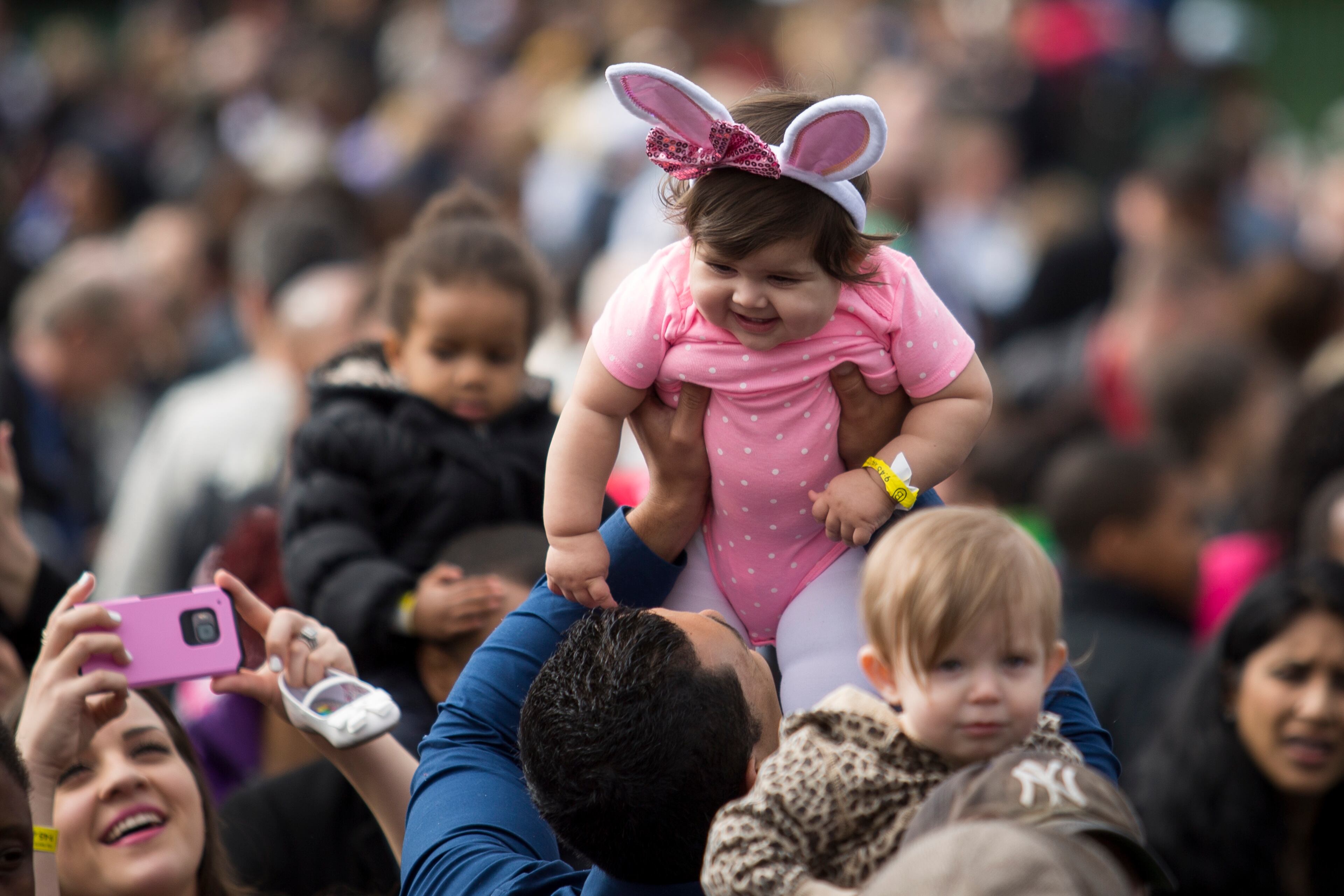 WASHINGTON, DC - MARCH 28: A child is raised up in the crowd before President Barack Obama and first lady Michelle Obama arrive to speak during the annual White House Easter Egg Roll on the South Lawn of the White House March 28, 2016 in Washington, DC. The tradition dates back to 1878 when President Rutherford B. Hayes allowed children to roll eggs on the South Lawn. (Photo by Drew Angerer/Getty Images)
