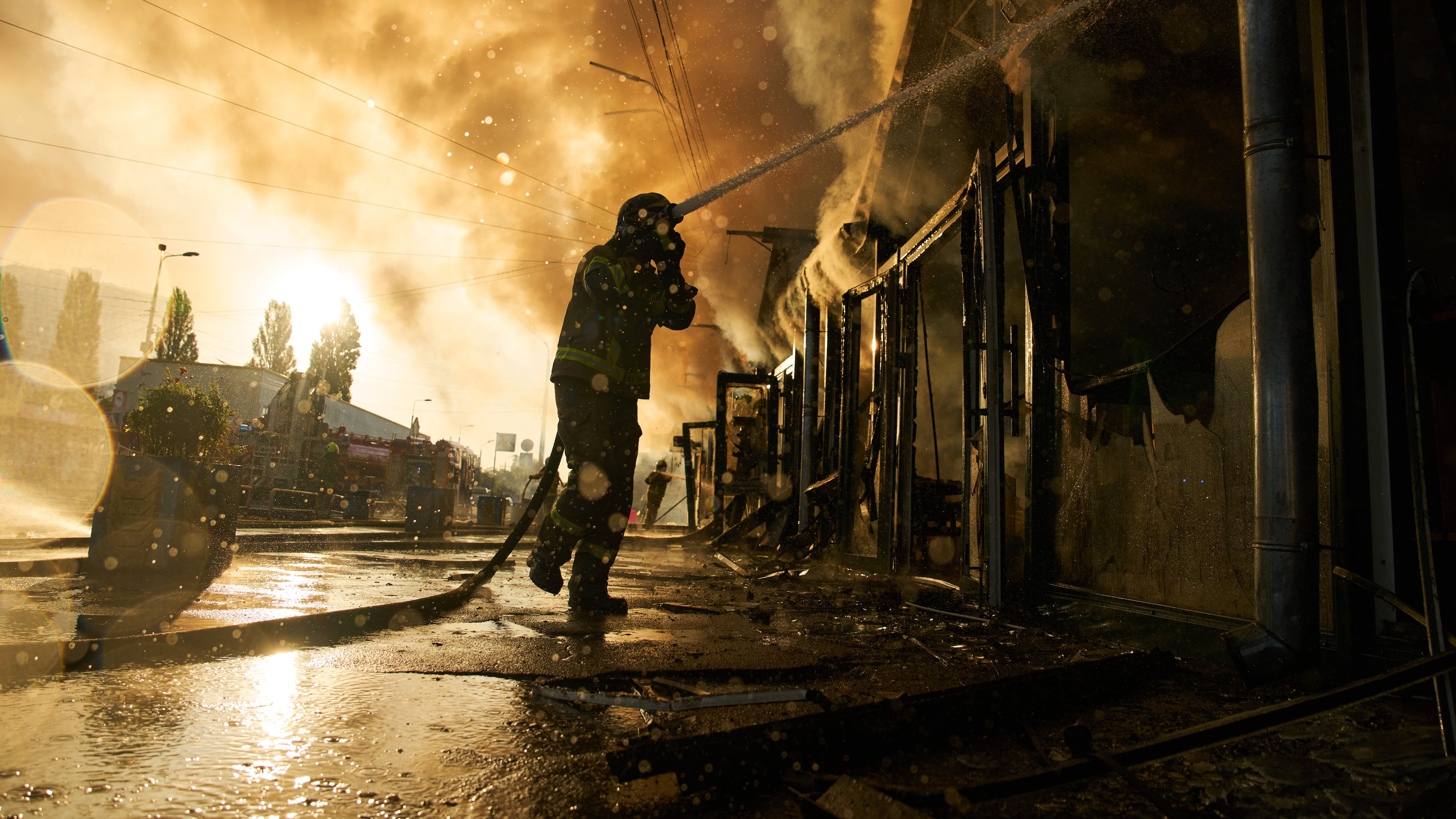 Firefighters try to put out a fire at a city book market following a Russian missile attack in Kyiv, Ukraine, early Sunday, Aug. 16, 2026. (AP Photo/Francisco Seco)