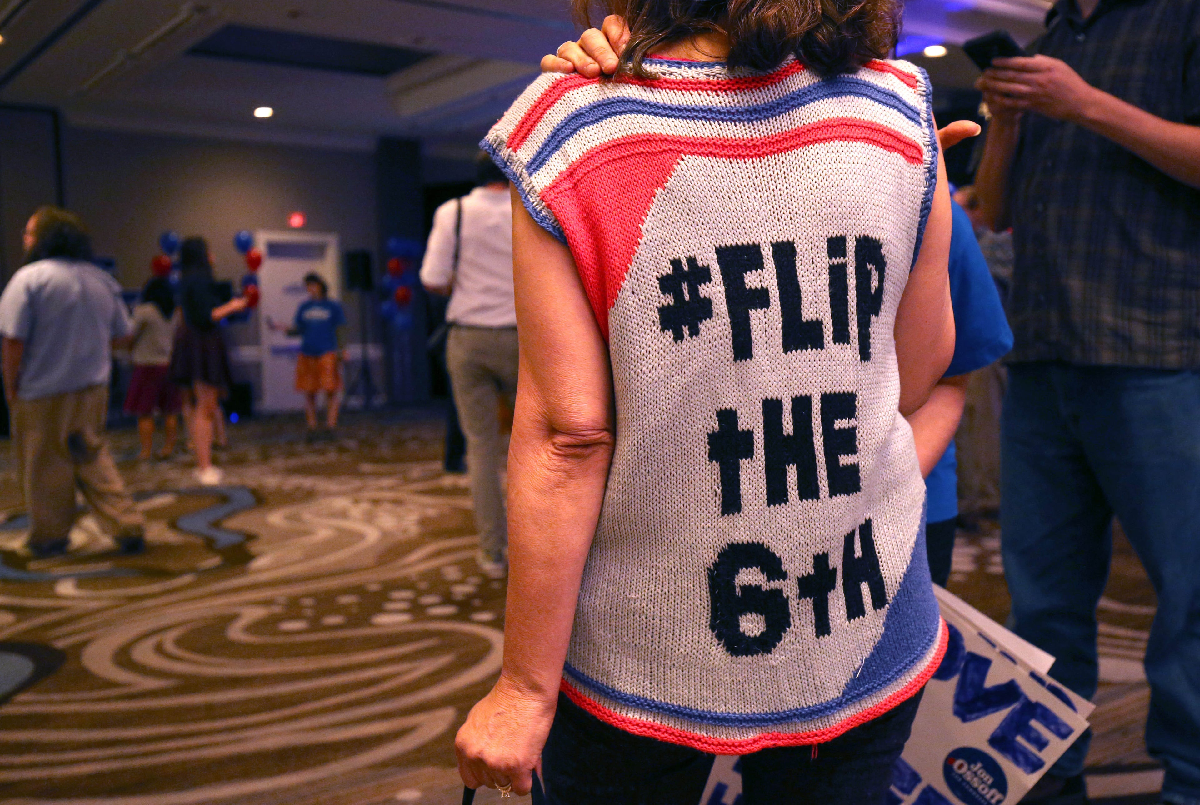June 20, 2017 - Atlanta, Ga: Jill Vogin, of Dunwoody, wears a sweater she made with the words, "Flip the 6th," as she arrives at the Jon Ossoff election night party at the Westin Atlanta Perimeter Hotel Tuesday, June 20, 2017, in Atlanta. This is the election coverage of the sixth district congressional runoff between Jon Ossoff and Karen Handel. PHOTO / JASON GETZ