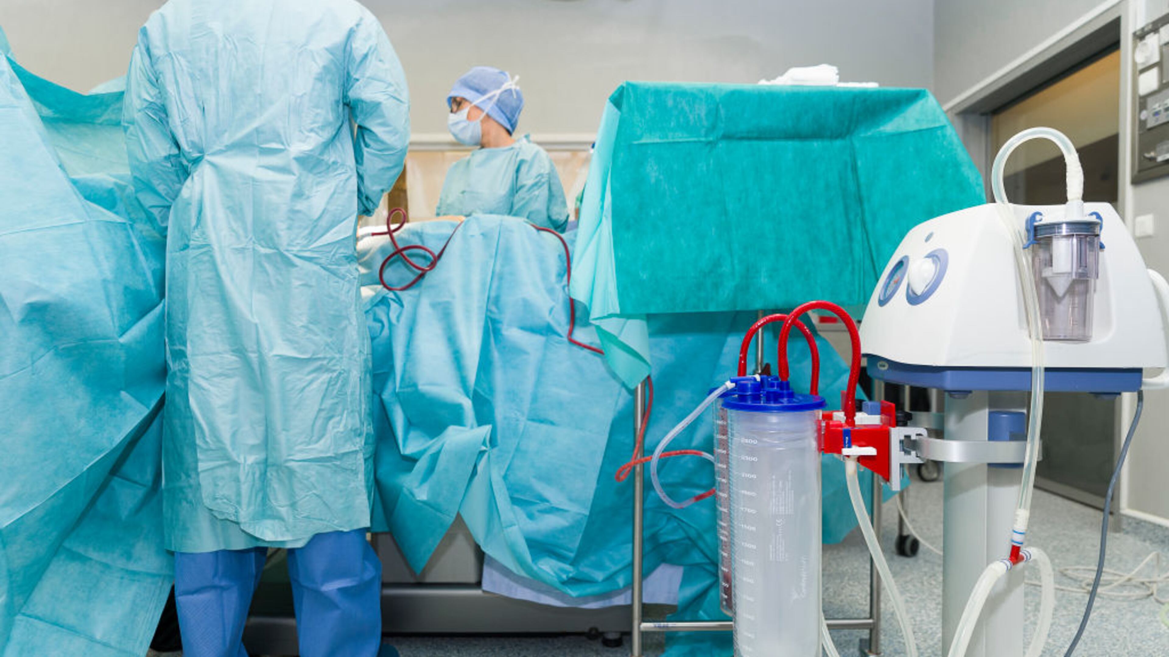 Doctors perform a weight loss surgery on a patient.