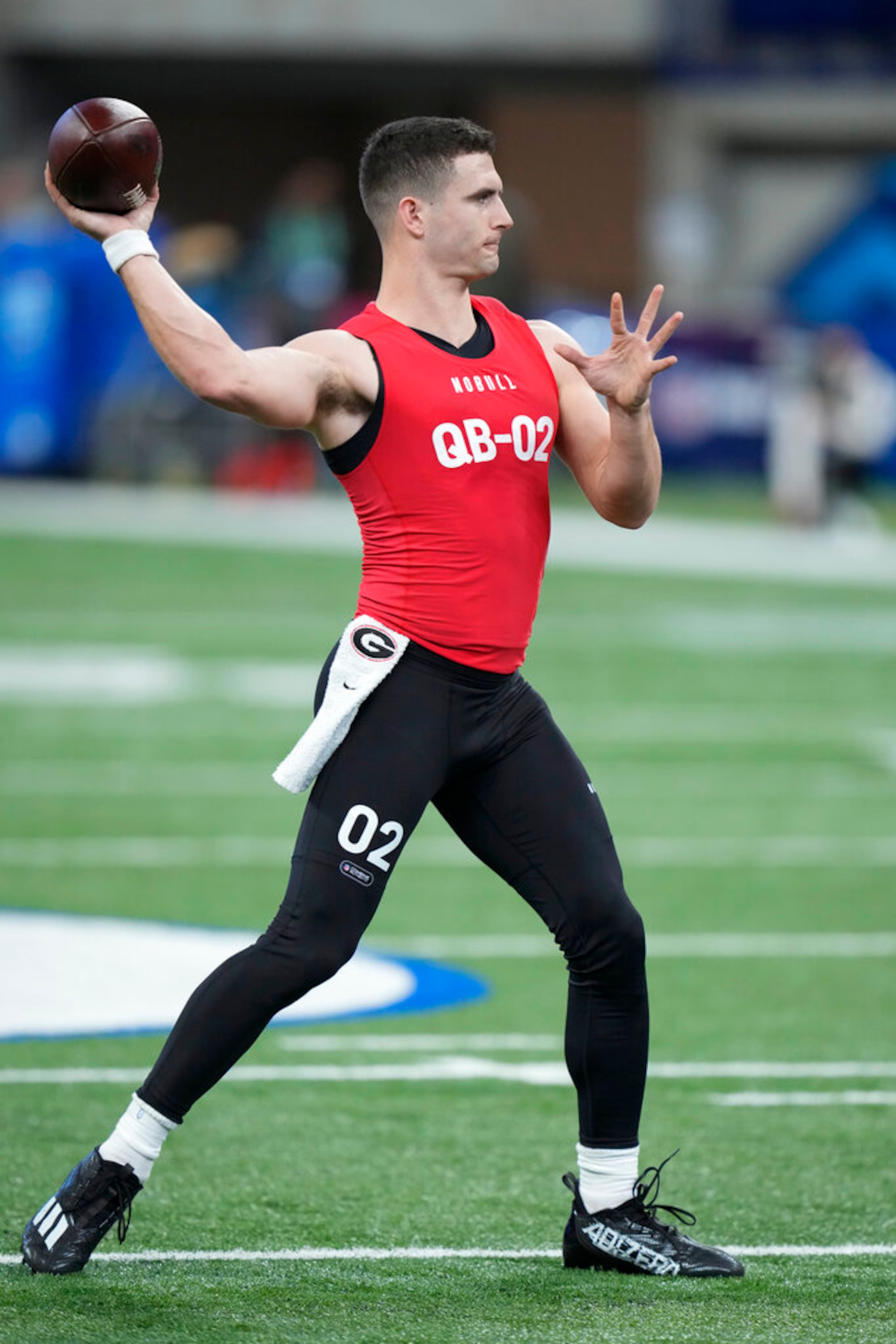 Georgia quarterback Stetson Bennett warms up before he runs a drill at the NFL football scouting combine in Indianapolis, Saturday, March 4, 2023. (AP Photo/Michael Conroy)