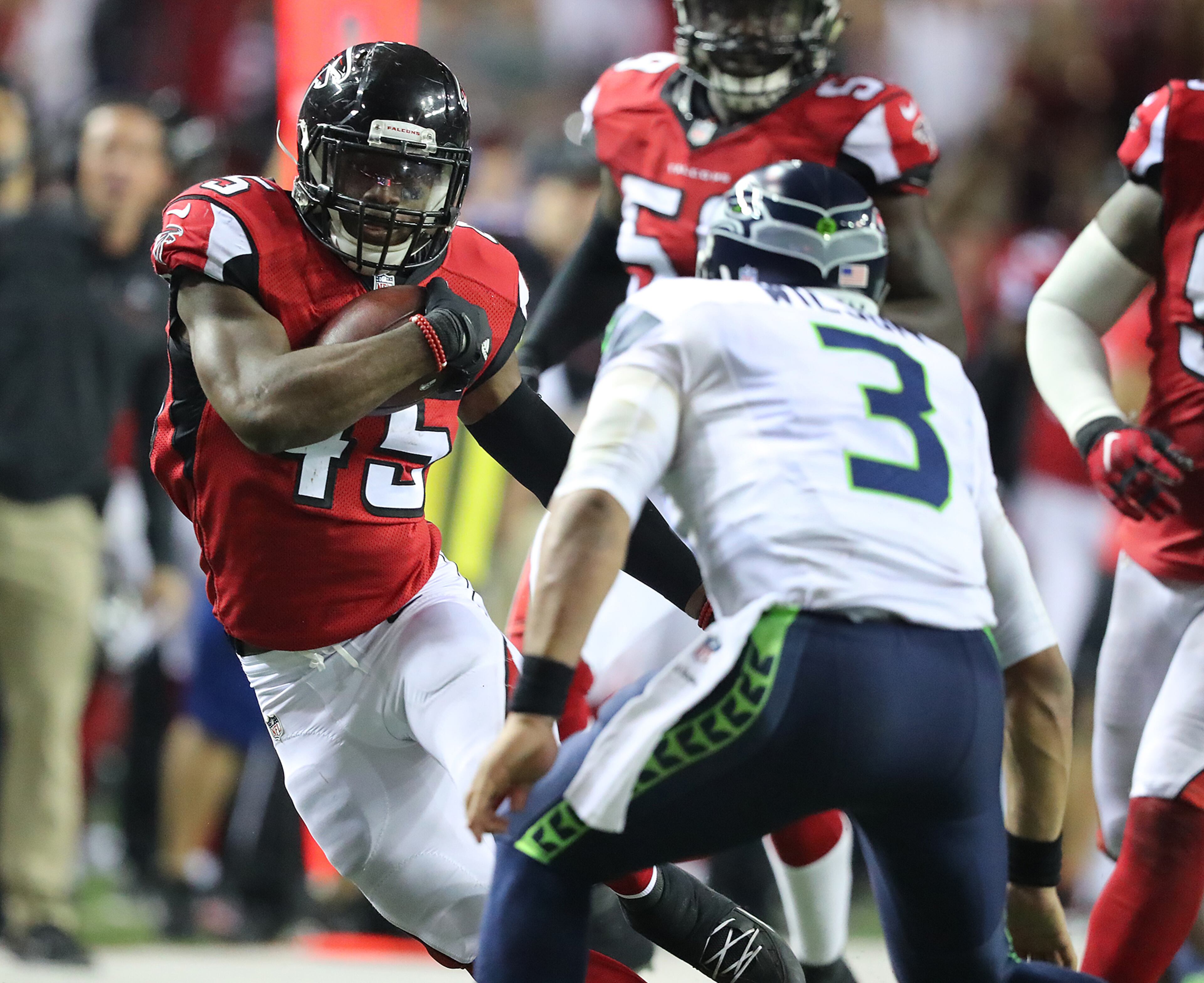 January 14, 2017, Atlanta: Falcons linebacker Deion Jones intercepts Seahawks quarterback Russell Wilson, who trys to make the tackle, in the final minutes of the fourth quarter to seal a 36-20 victory in a NFL football NFC divisional playoff game on Saturday, Jan. 14, 2017, in Atlanta. Curtis Compton/ccompton@ajc.com