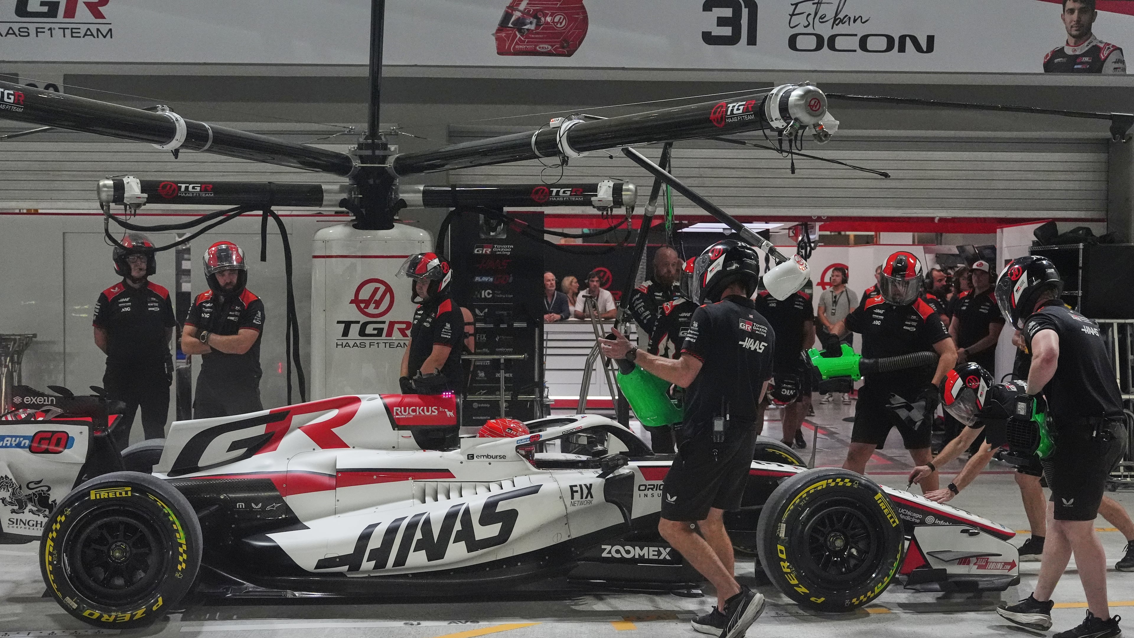 Haas driver Esteban Ocon of France gets a pit service during the sprint qualifying session ahead of the Singapore Formula One Grand Prix in Singapore, Friday, Oct. 9, 2026. (AP Photo/Ng Han Guan, Pool)