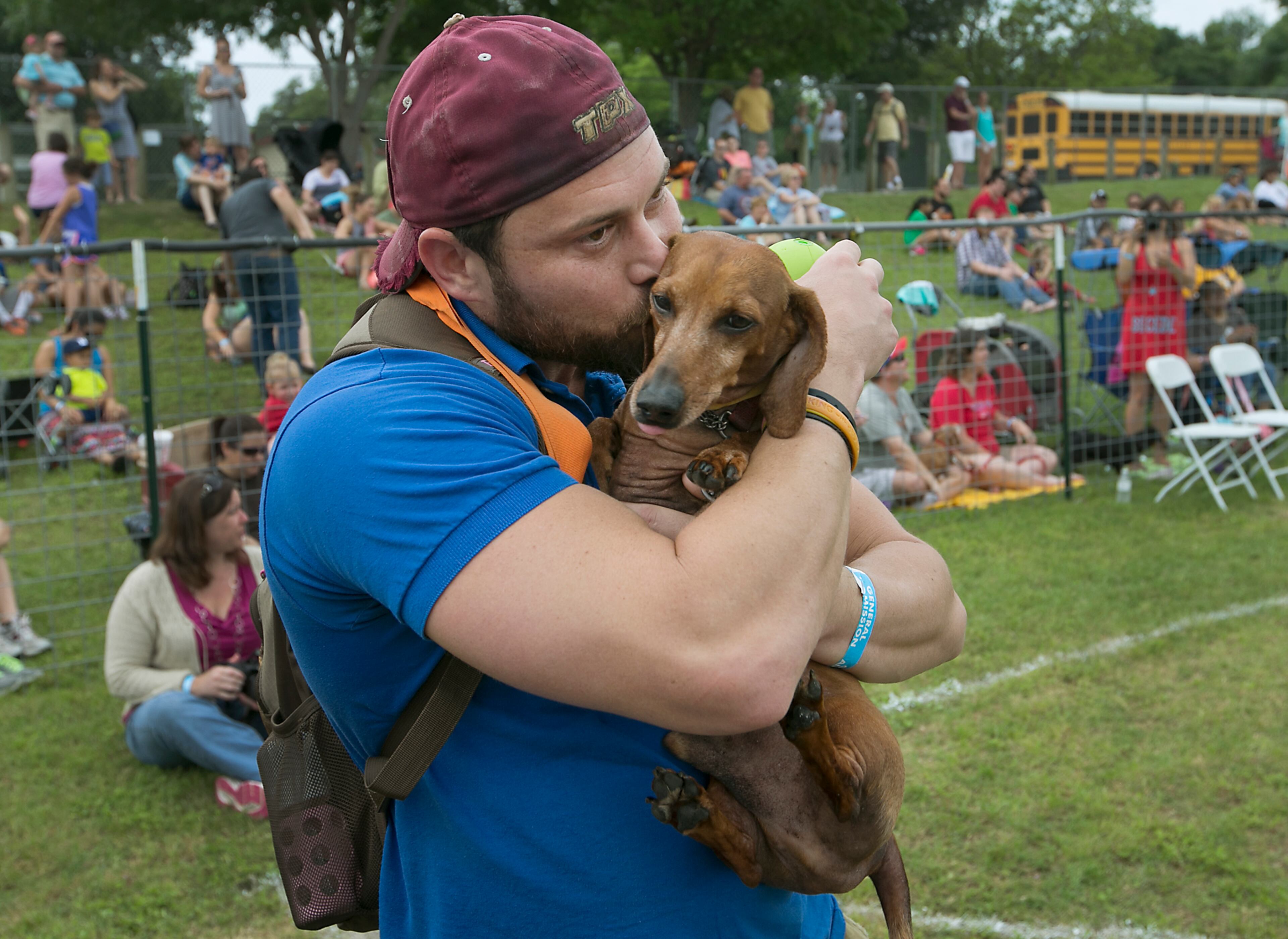 Bill Brumley hugs his dog Spanky after he qualified for the quarterfinals. The 18th Annual Buda County Fair and Weiner Dog Races was held at city park in Buda Sunday April 26, 2015 sponsored by the Lions Club. RALPH BARRERA/ AMERICAN-STATESMAN