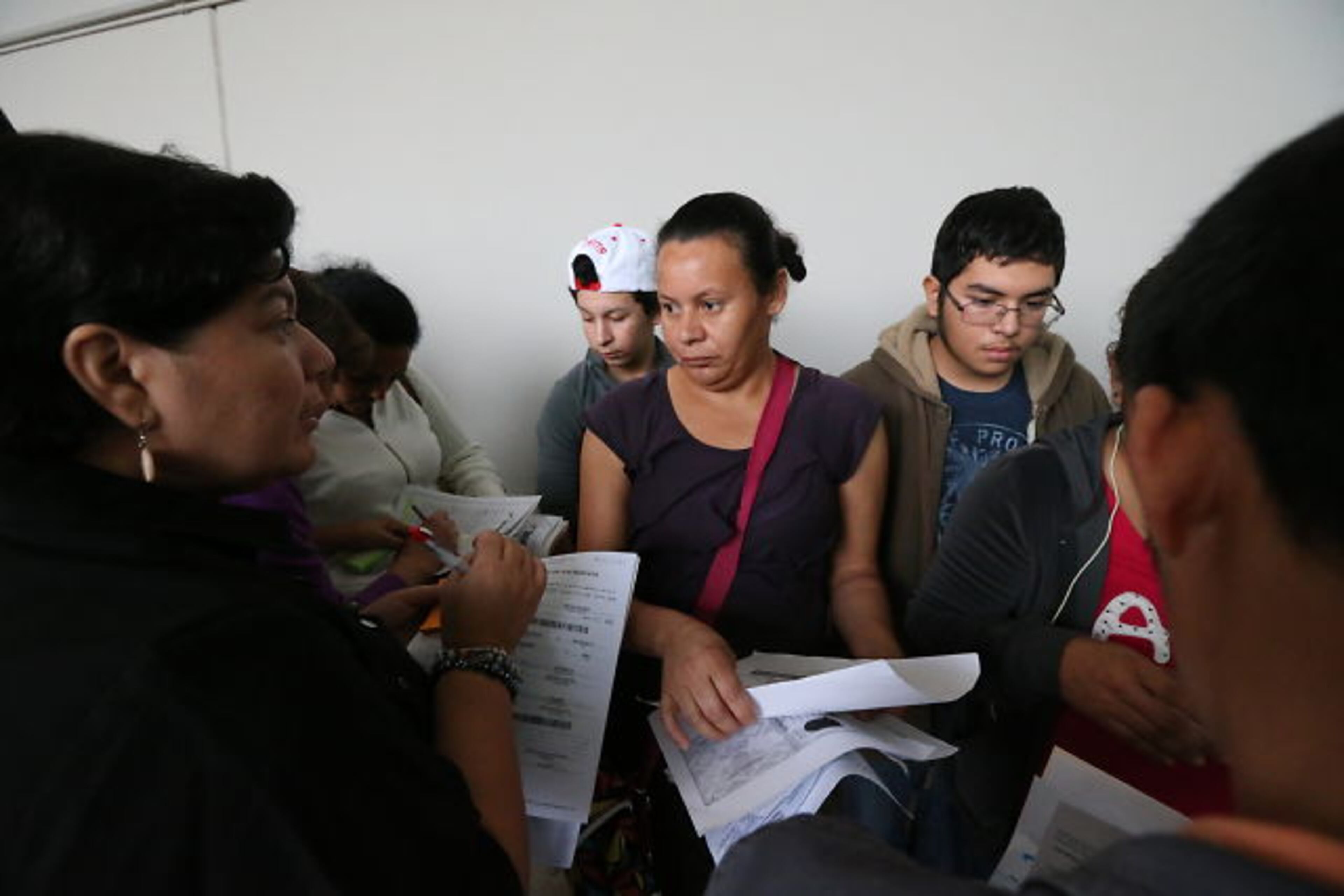 Hoping to get their children enrolled in DeKalb County Schools, immigrant families spent Thursday night and early Friday lined up with their children outside district headquarters.