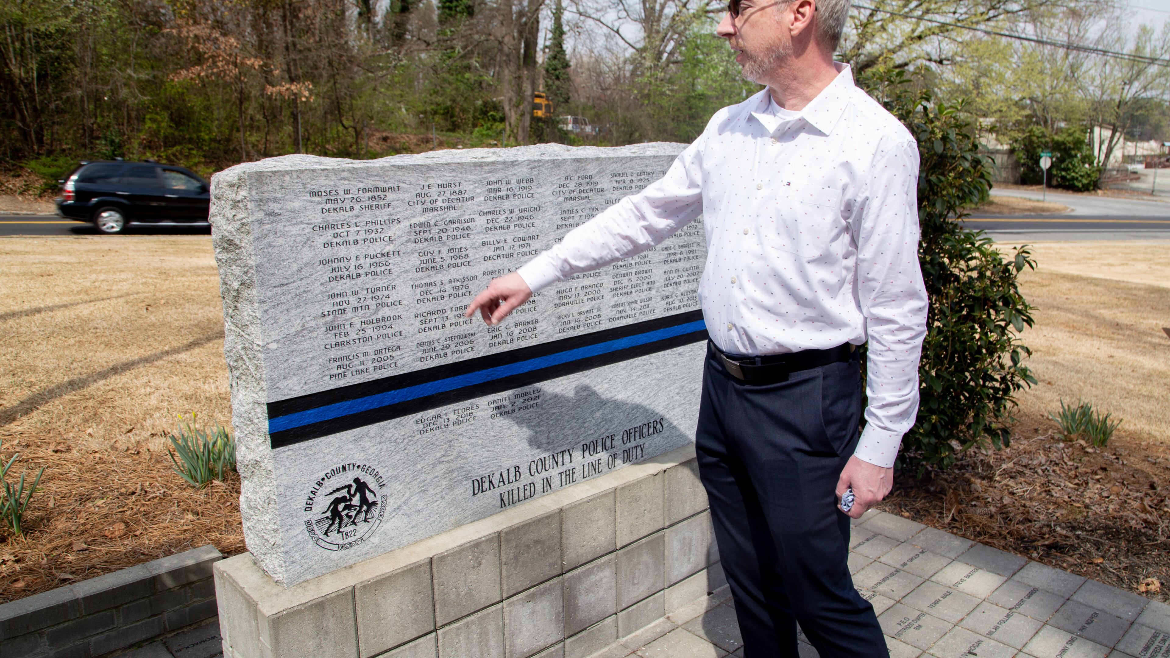 City Councilman Brian Mock talks about the Dekalb County Police Officers Killed in the Line of Duty memorial near Dresden Park in Chamblee on March 14, 2021. STEVE SCHAEFER FOR THE ATLANTA JOURNAL-CONSTITUTION