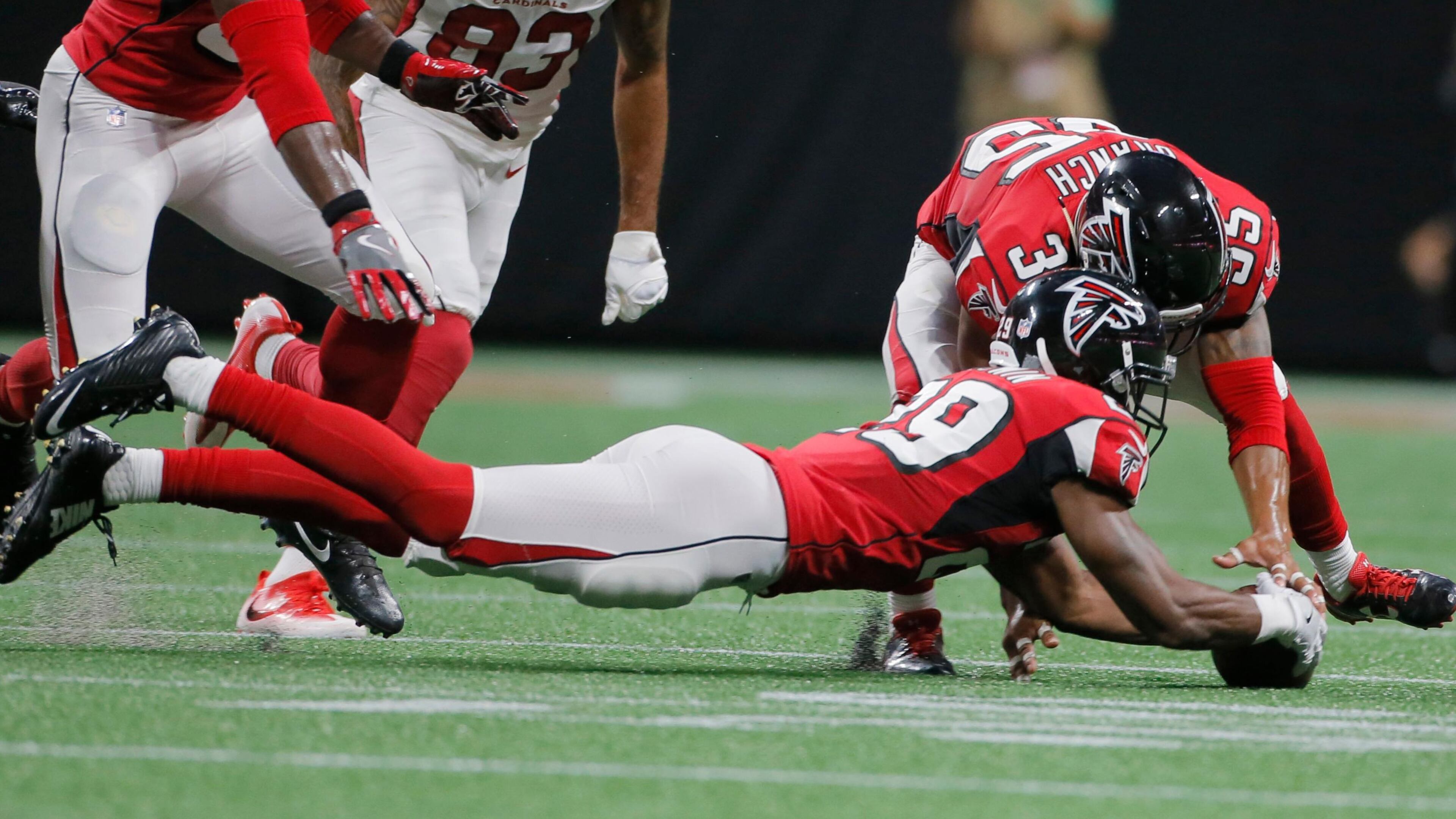 8/26/17 - Atlanta, GA - Atlanta Falcons cornerback C.J. Goodwin (29) recovers a fumble in the second half with help from Atlanta Falcons defensive back Marcelis Branch (35). The first game in Mercedes-Benz Stadium was Saturday, as the Atlanta Falcons played Arizona in an exhibition game.. BOB ANDRES /BANDRES@AJC.COM