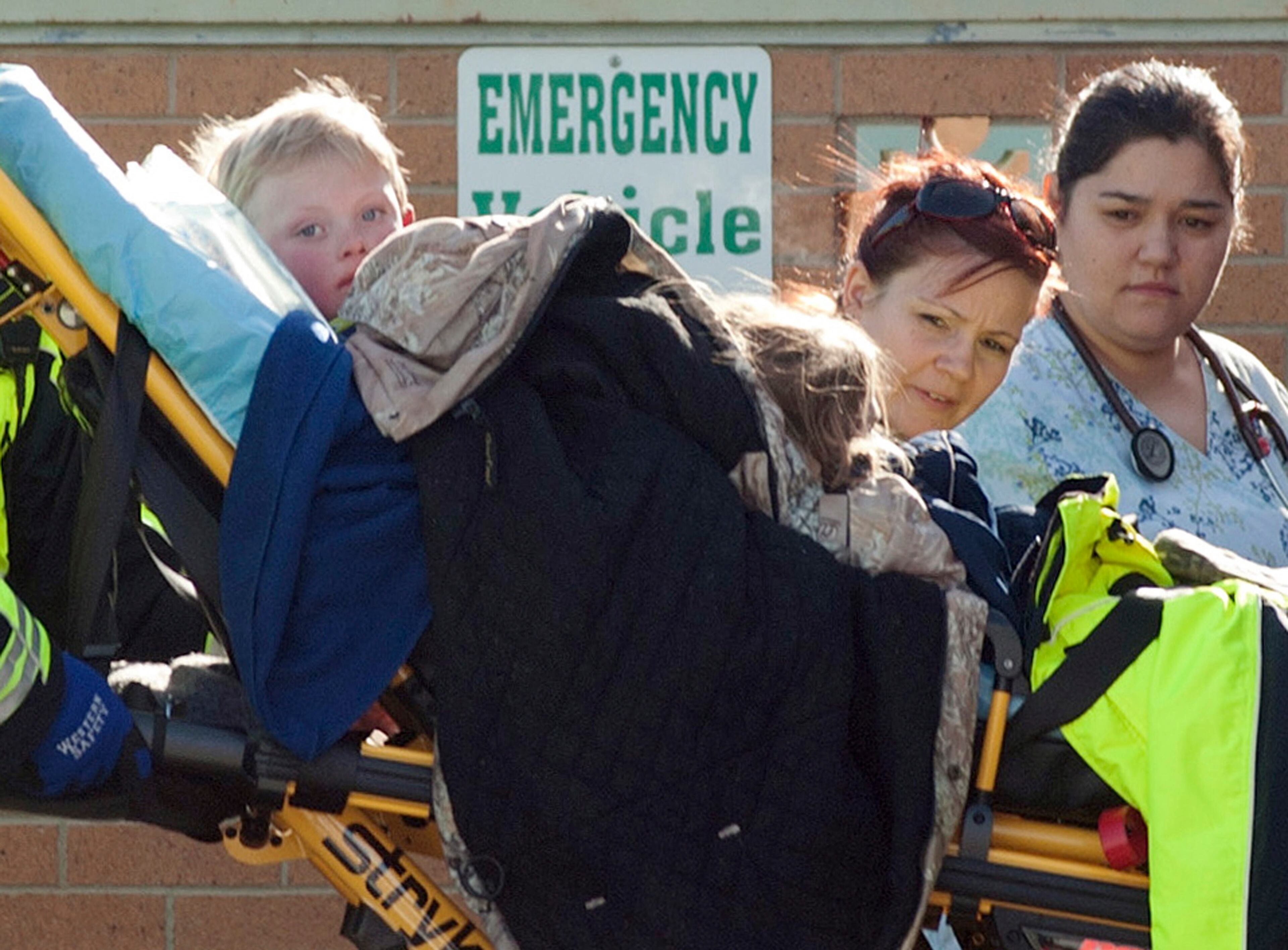 Members of a family that went missing are wheeled by stretcher from an ambulance into the Pershing General Hospital in Lovelock, Nevada, December 10, 2013. A Nevada couple and four young children reported missing on Sunday in a remote mountain range northeast of Reno were found safe by rescue workers on Tuesday huddled in a canyon, a dispatch supervisor for the Pershing County Sheriff's Office said. RECROP OF NV650 REUTERS/James Glover