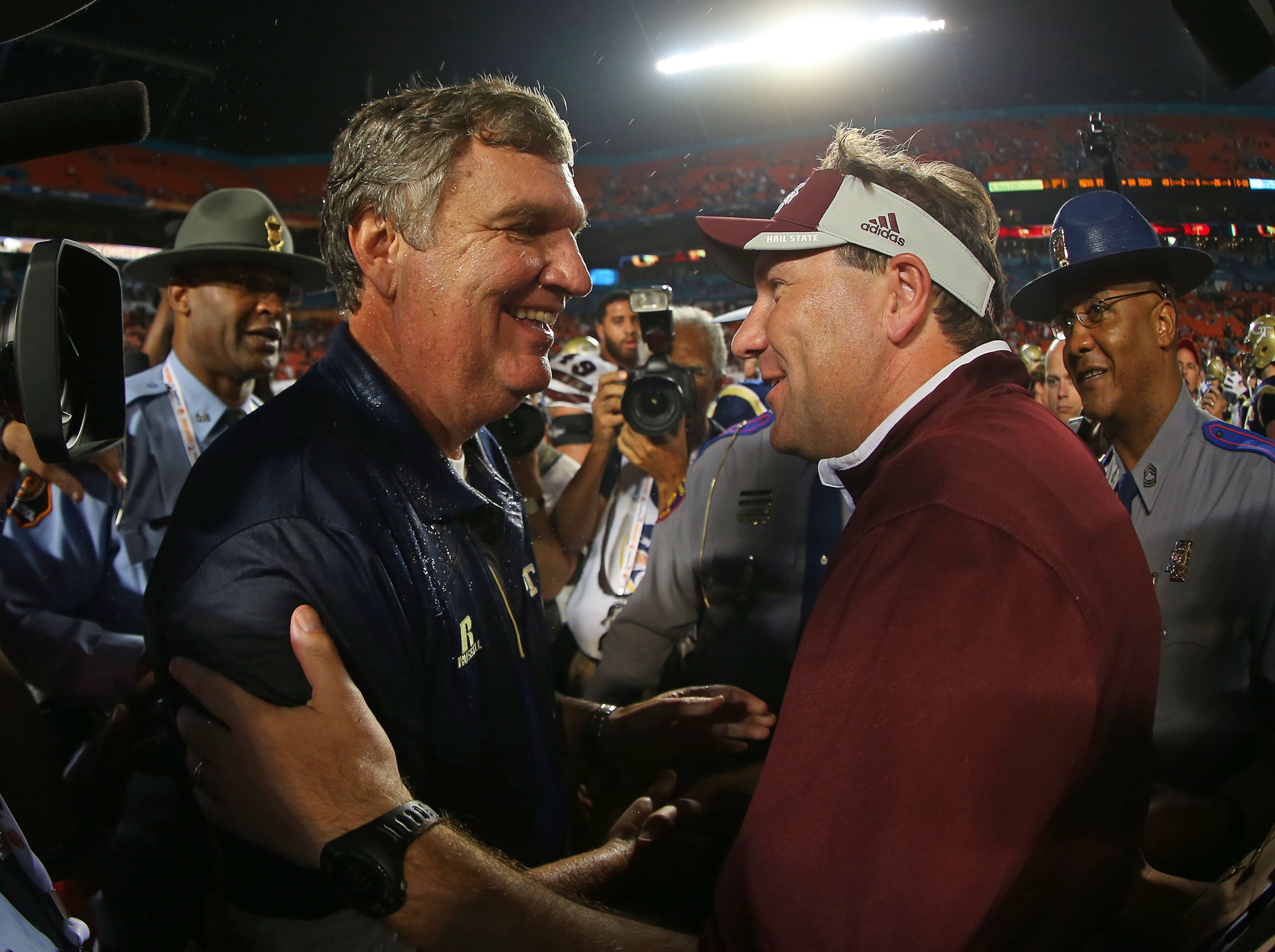 Head coach Paul Johnson of the Georgia Tech Yellow Jackets and head coach Dan Mullen of the Mississippi State Bulldogs shake hands after the Capital One Orange Bowl game at Sun Life Stadium on December 31, 2014 in Miami Gardens, Florida. (Photo by Mike Ehrmann/Getty Images)
