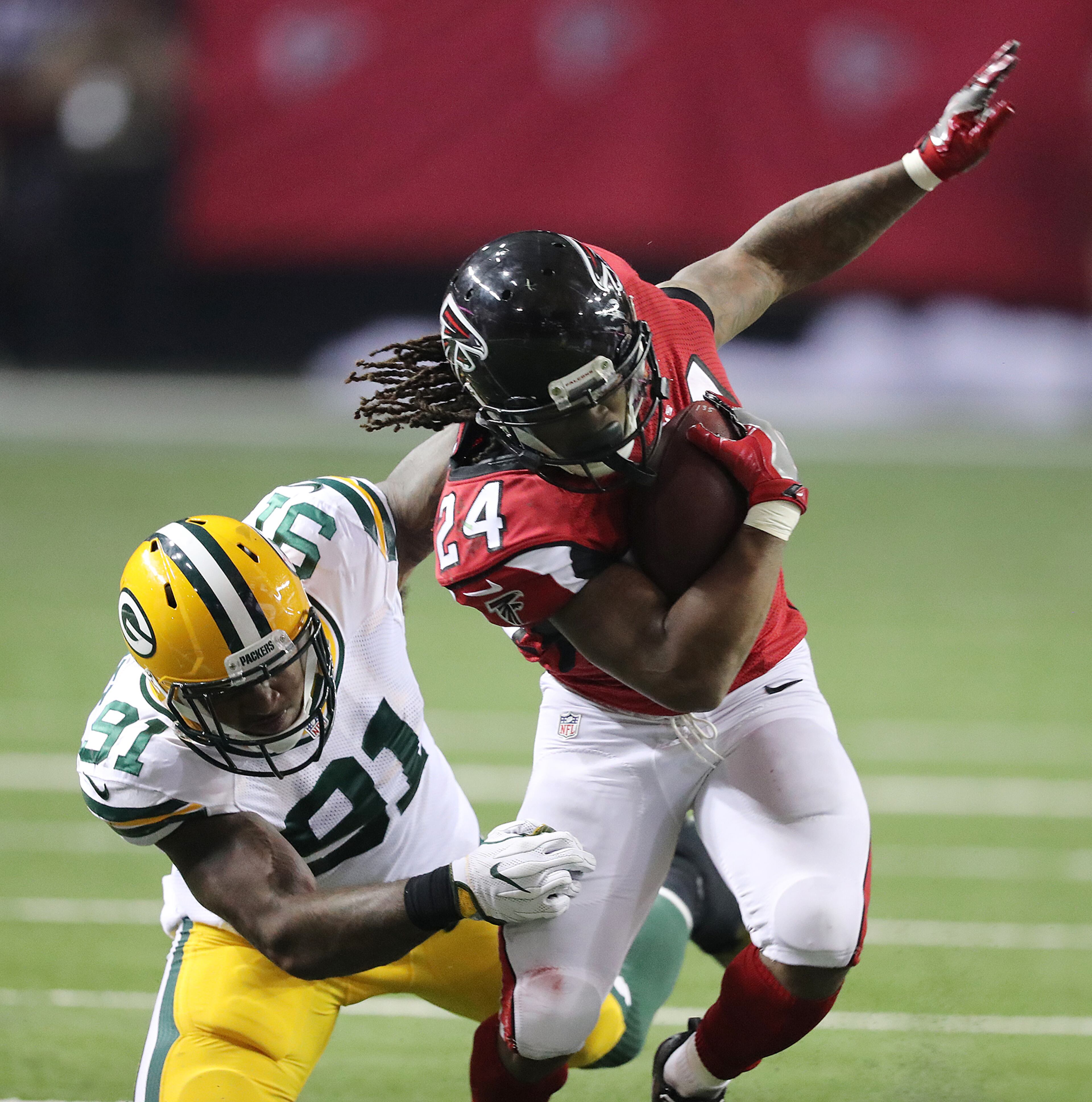 October 30, 2016 ATLANTA: Falcons running back Devonta Freeman gets past Packers Jayrone Elliott for yardage during the second half in an NFL football game on Sunday, Oct. 30, 2016, in Atlanta. Curtis Compton /ccompton@ajc.com