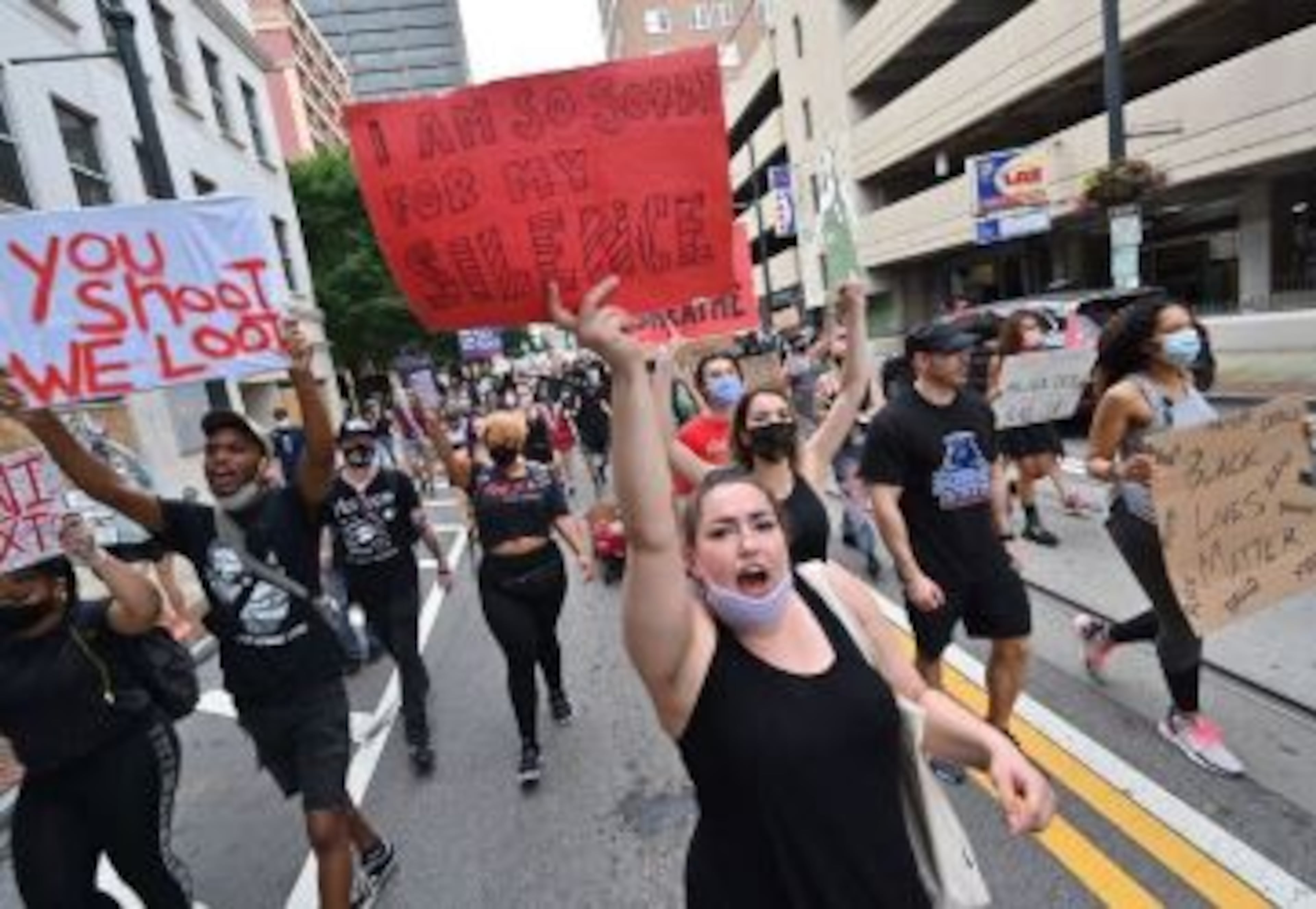 Protesters voice their opinions with signs Friday in Atlanta.