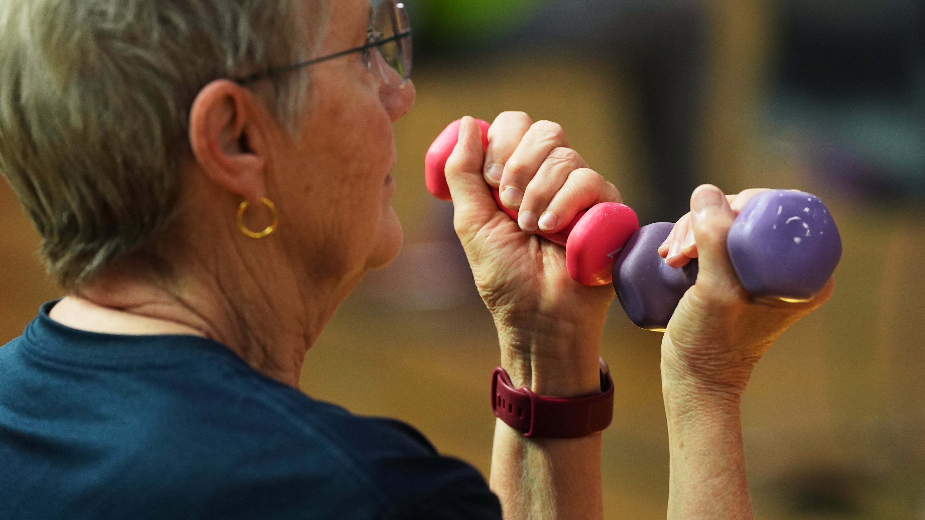 FILE - A participant uses light weights during a class for older adults at the Dale Turner Family YMCA in Shoreline, Wash., April 30, 2026. (AP Photo/Lindsey Wasson, File)
