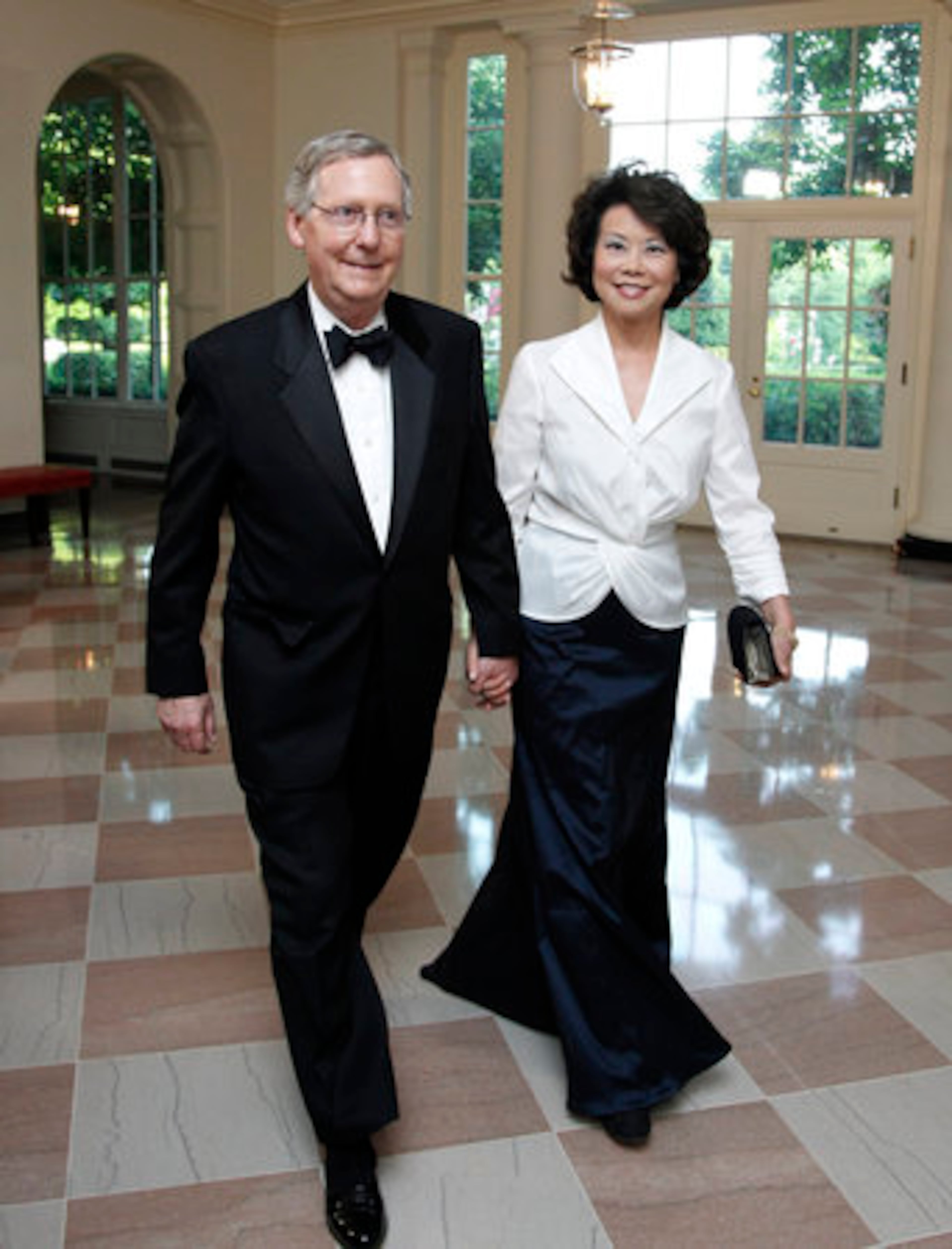Senate Republican Leader Sen. Mitch McConnell, R-Ky., and his wife former Labor Secretary Elaine Chao, arrive for the dinner hosted by President Barack Obama and first lady Michelle Obama.