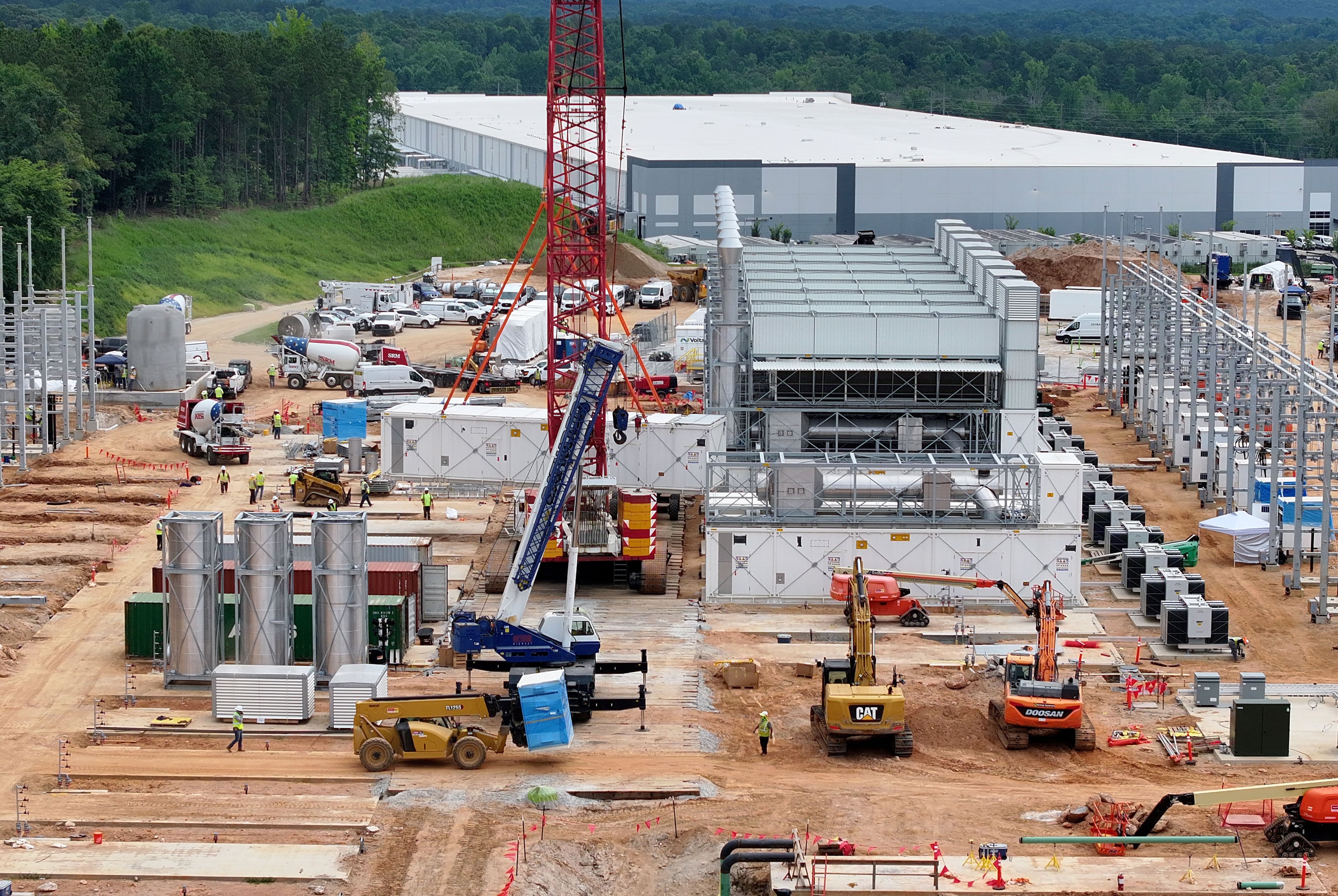Aerial view of off-grid generators being installed, with the data center in the background, on Thursday, June 25, 2026, in Covington. A data center near Social Circle plans to get its primary power supply from a set of off-grid generators, the first setup of its kind in Georgia. But the company behind the power project is already installing its equipment, despite never obtaining proper permits from the state, a move environmental advocates say raises serious questions about oversight of data centers cropping up across Georgia. (Hyosub Shin/AJC)