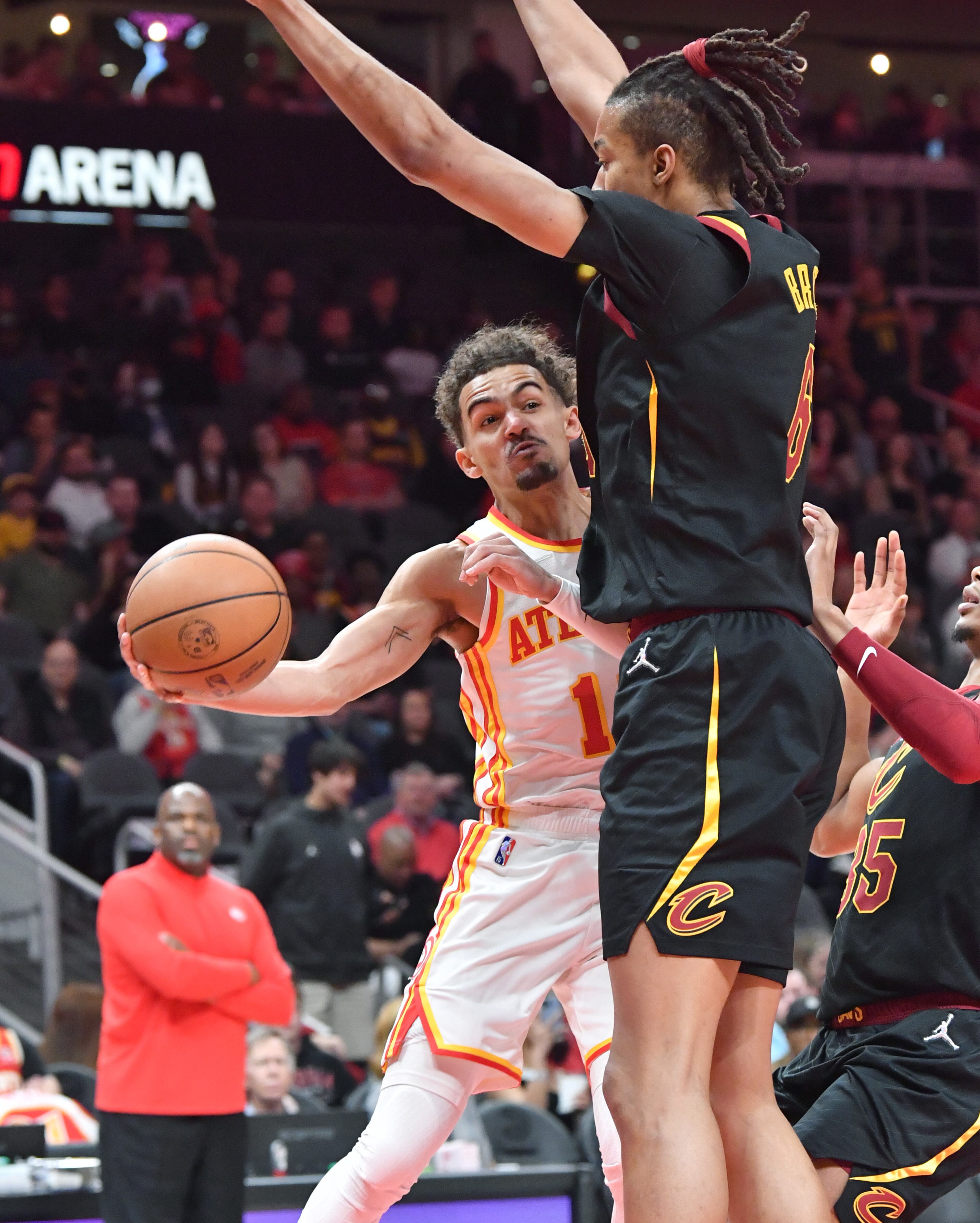 Hawks' guard Trae Young (11) gets off a pass around Cleveland Cavaliers' center Moses Brown (6) during the first half in an NBA basketball game at State Farm Arena on Thursday, March 31, 2022. Atlanta Hawks won 131-107 over Cleveland Cavaliers. (Hyosub Shin / Hyosub.Shin@ajc.com)