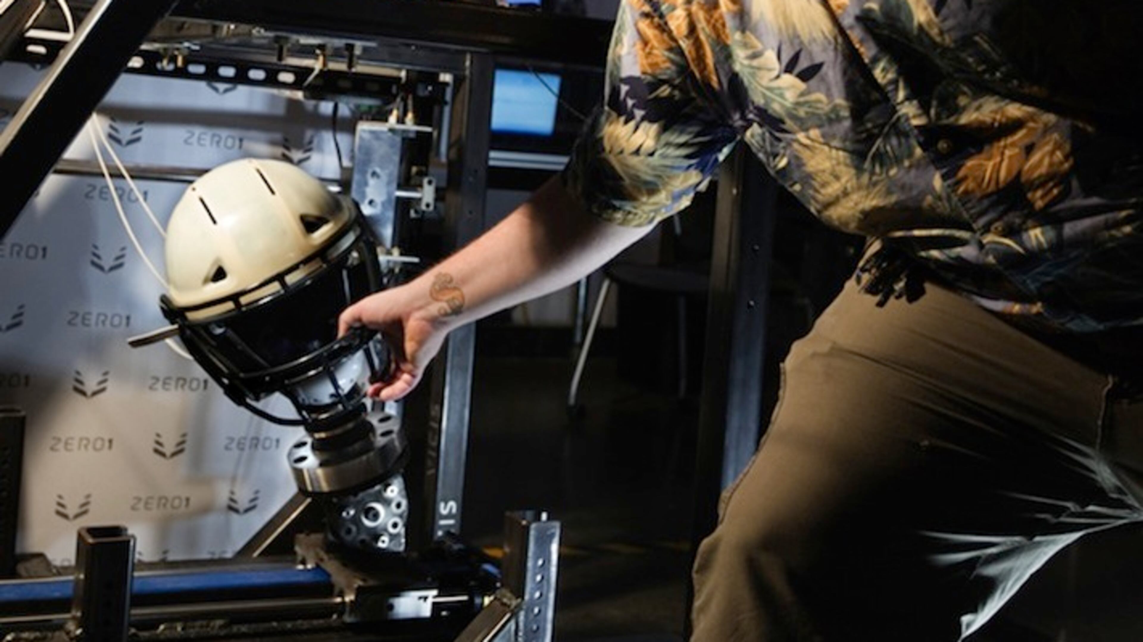 Vicis engineering technician Steven Reddell positions the Vicis football helmet to be hit by the pendulum at the company's smash lab in Seattle. (Steve Ringman/Seattle Times/TNS)