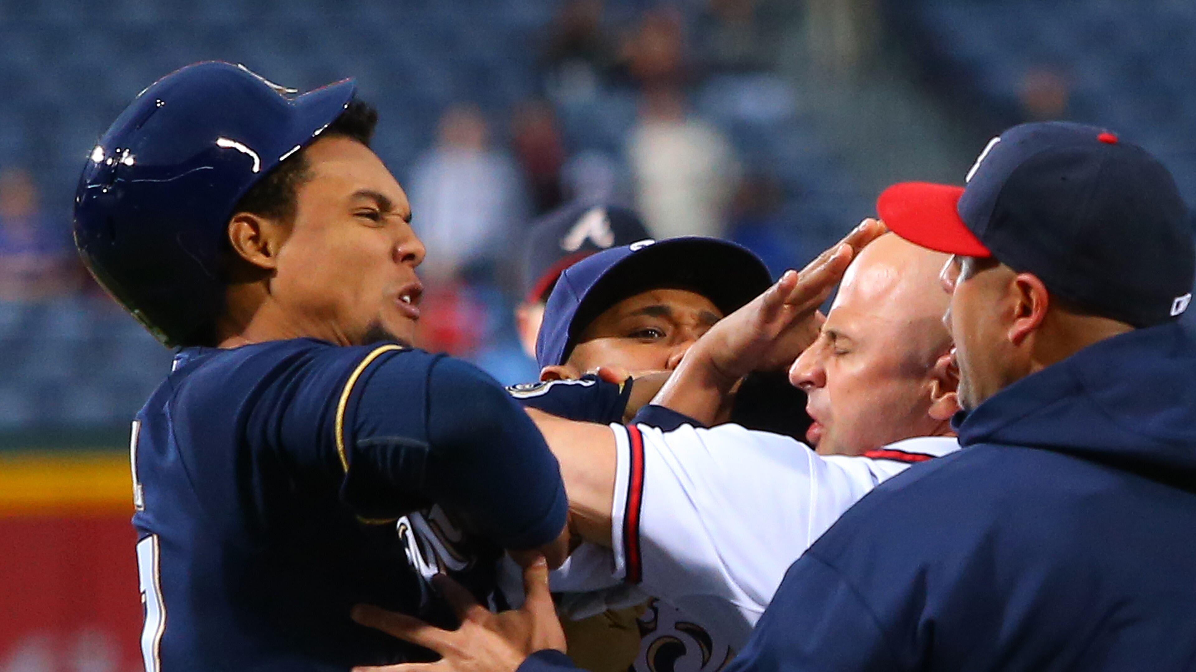 Brewers Carlos Gomez (left) and Braves Reed Johnson (second from right) exchange blows when both benches clear after Braves catcher Brian McCann confronted Gomez for show boating Braves pitcher Paul Maholm on a solo home run during the first inning on Wednesday, Sept. 25, 2013, in Atlanta.