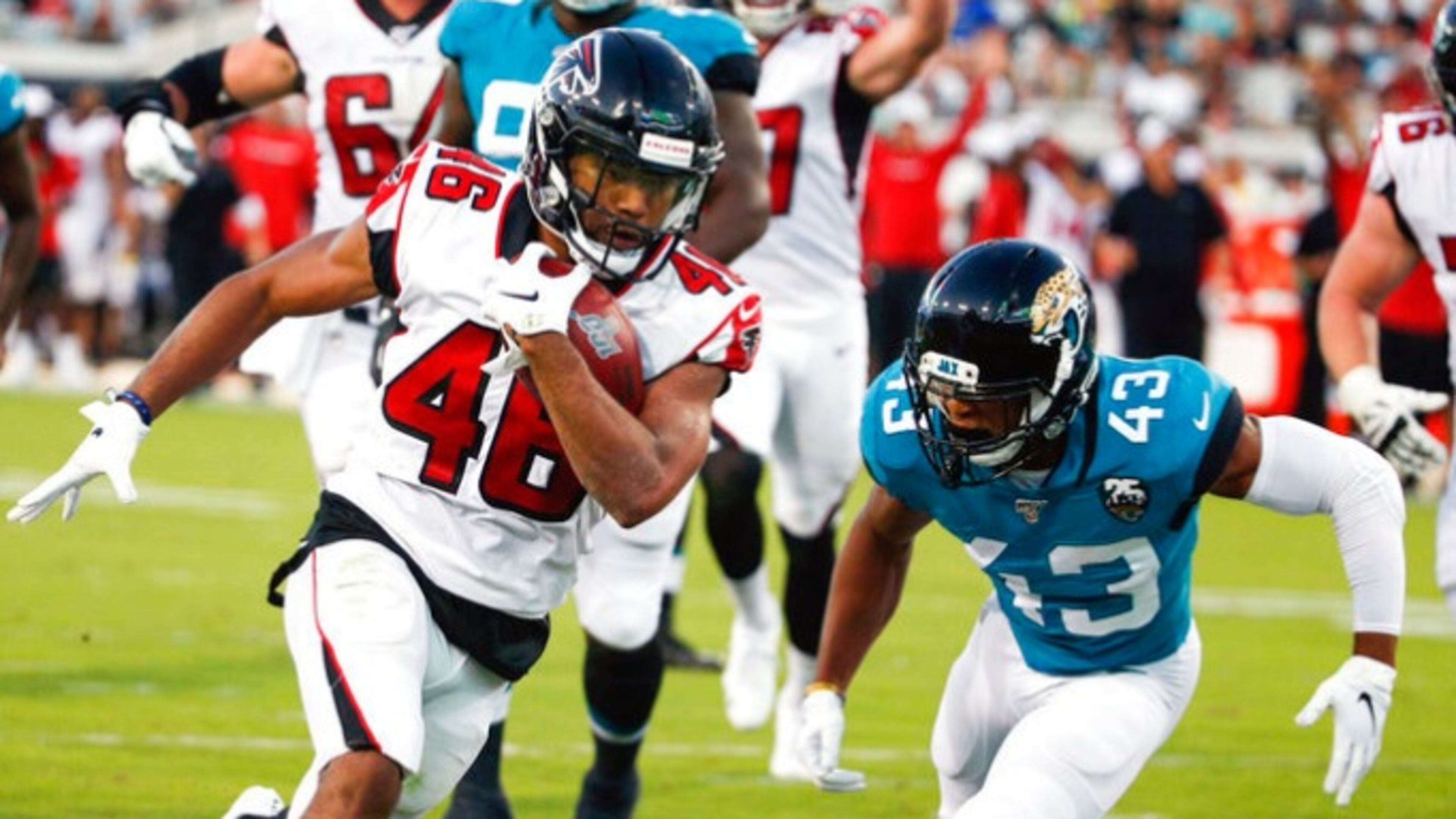 Atlanta Falcons running back Tony Brooks-James, left, runs past Jacksonville Jaguars defensive back Picasso Nelson (43) for a 15-yard touchdown run during the first half of an NFL preseason football game, Thursday, Aug. 29, 2019, in Jacksonville, Fla. (AP Photo/Stephen B. Morton)