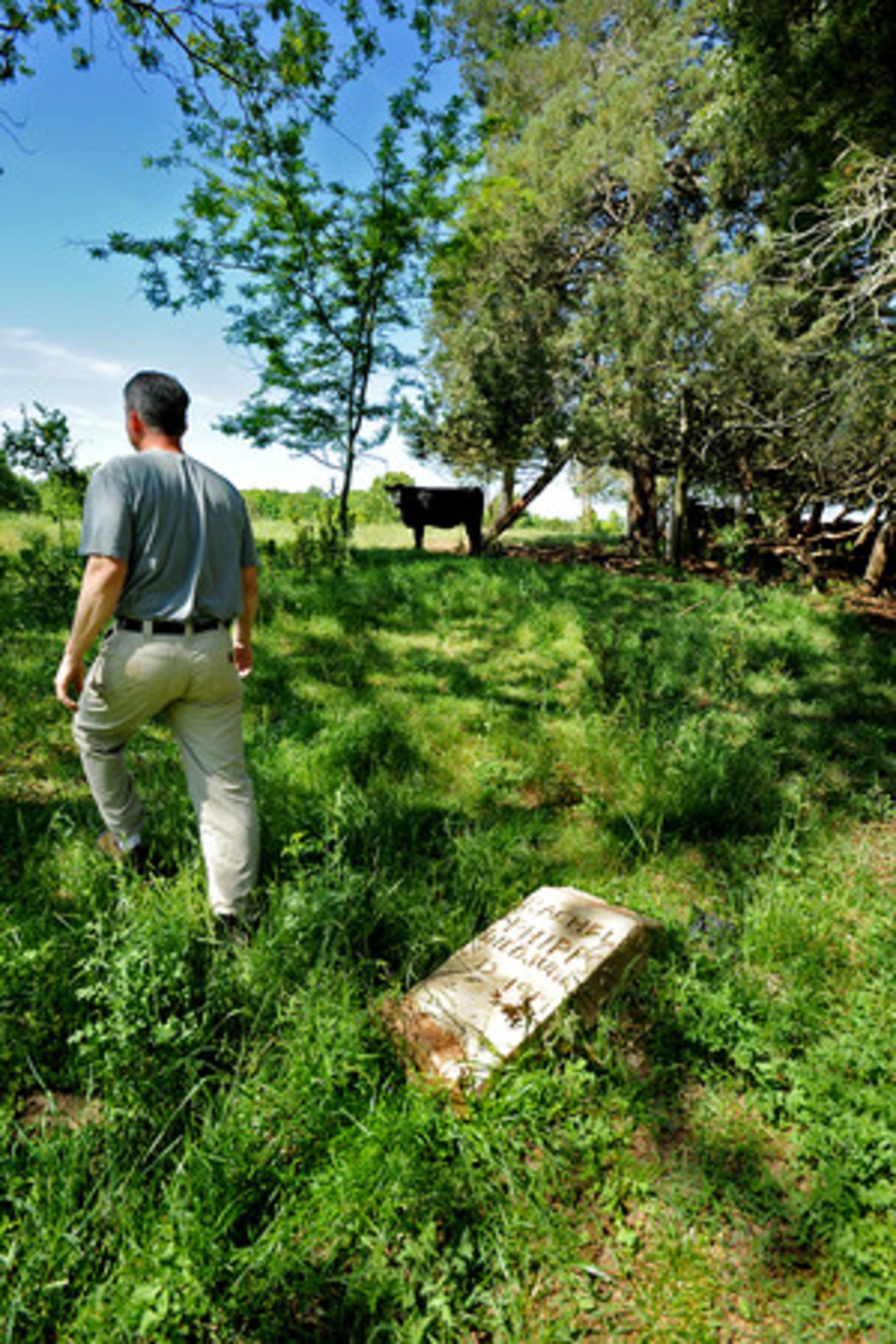 Hequembourg walks away from a grave marker belonging to a share cropper who once farmed the property. Hequembourg's wife, Hope, is a member of the influential Benton family. Some of her relatives helped found Bank of Monticello and Georgia Marble Co. They acquired the plantation in Georgia's second land lottery, in 1807.