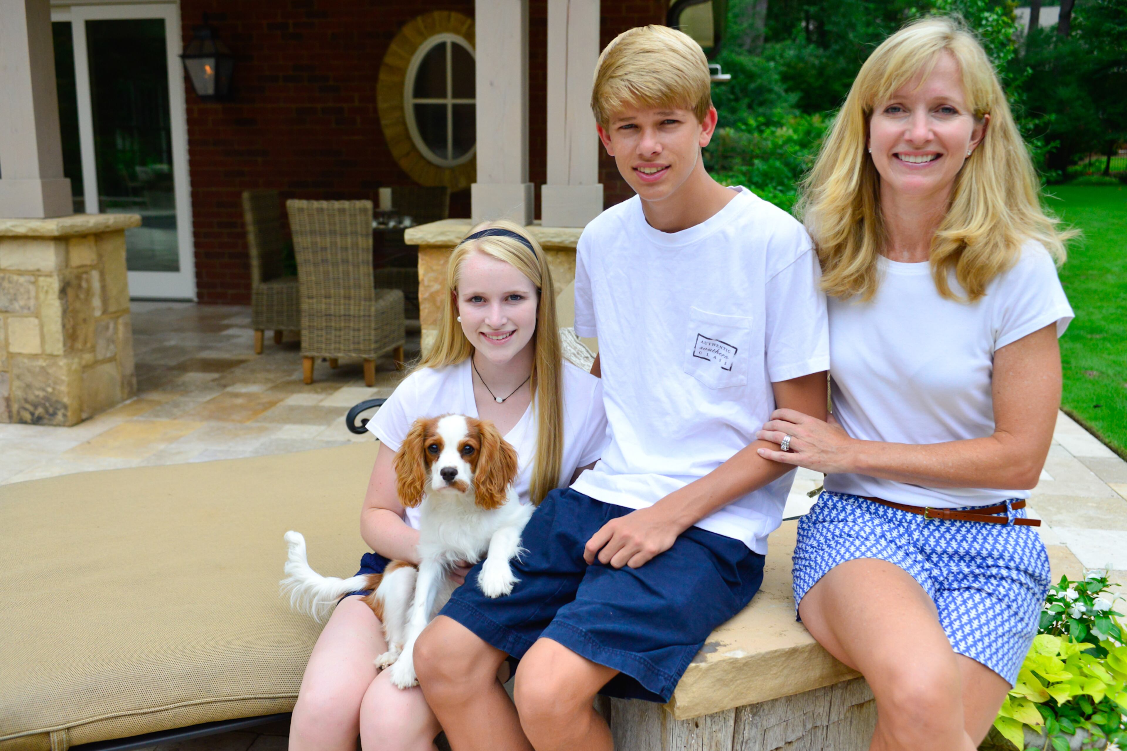 Beth Sharon sits with her two children, Holland and Will, behind their Duluth home. Now, the spaces are used often by their teenage kids and their friends, as well as for events such as seafood boils and guest space for overnight visitors. -- Text by Lori Johnston