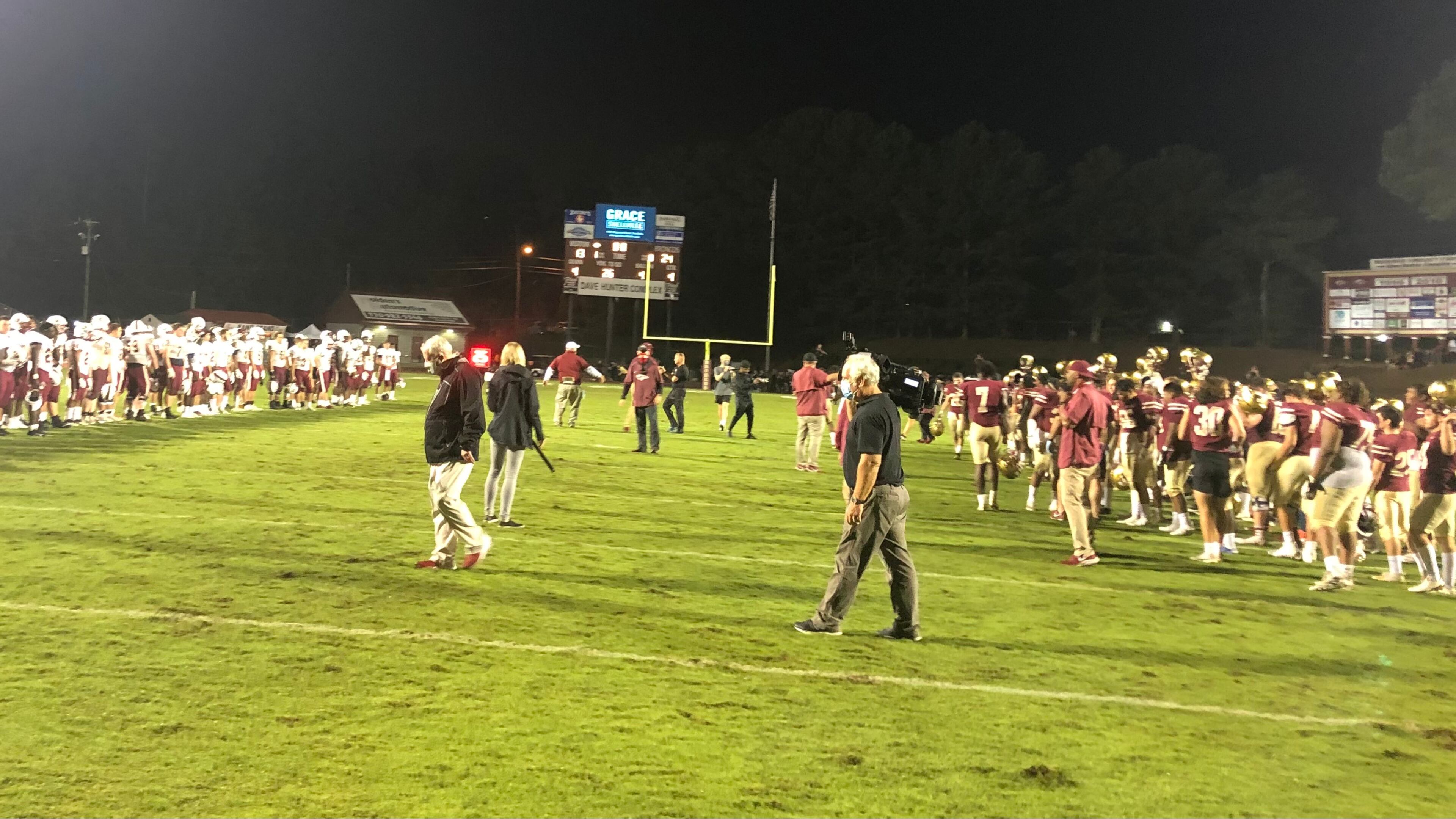 No handshakes were allowed, so the Mill Creek (left) and Brookwood teams exchange socially distanced congratulations after Friday's game.