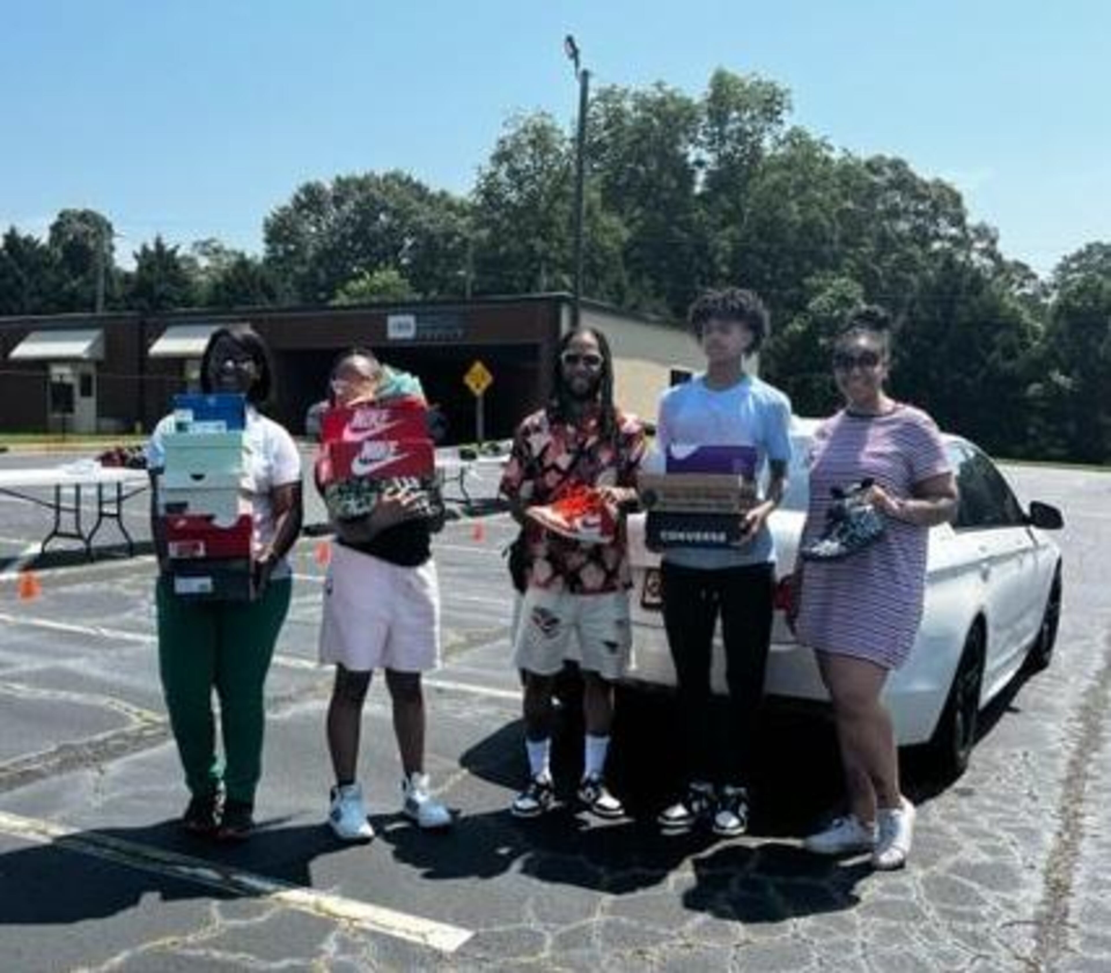 Joe’L Montez,(middle) co-owner of Sneaka Plug in Stockbridge donates 12 pairs of shoes during the July 1 drive for the Kicks for Kids cause. (Photo provided by Clayton News-Daily)