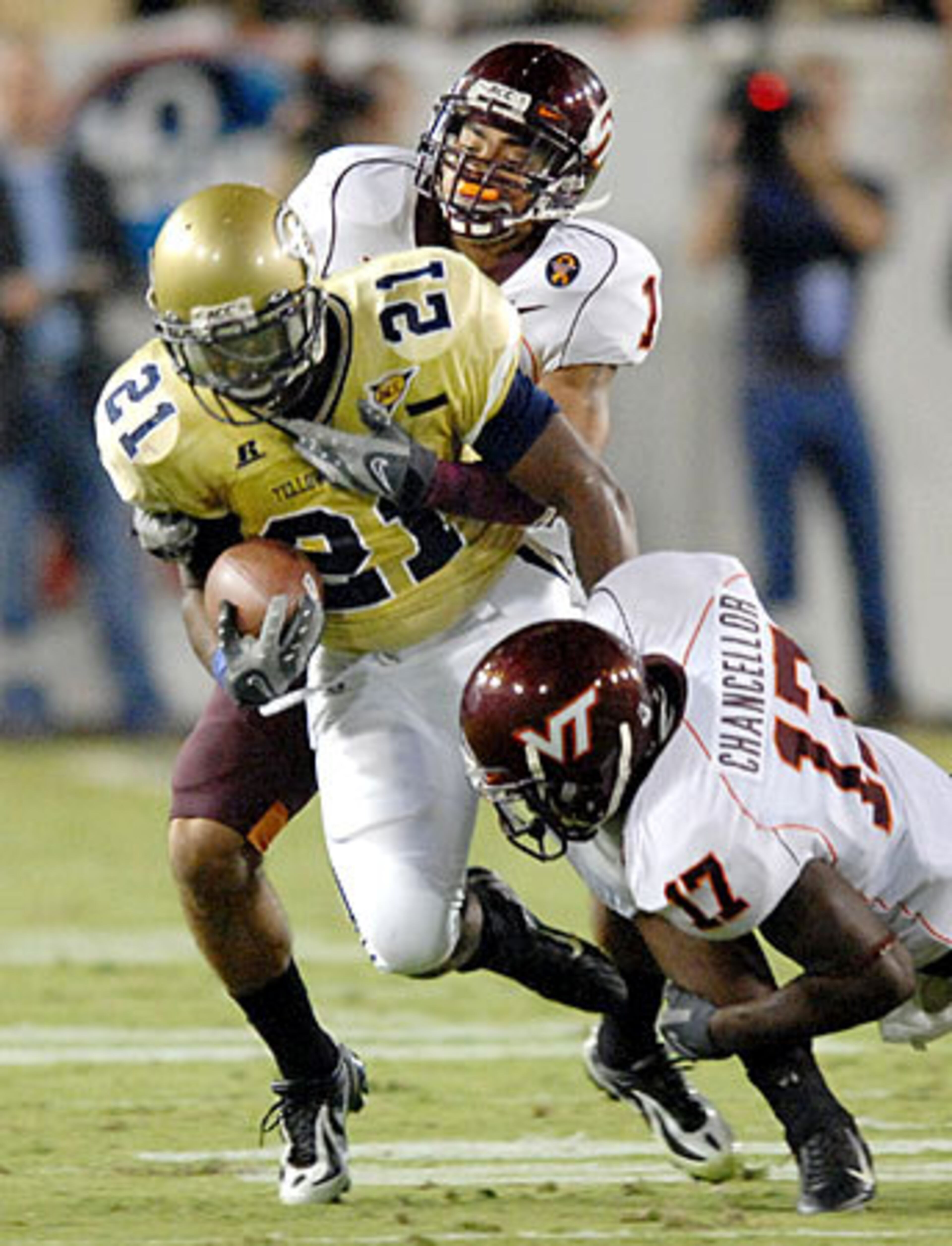 Georgia Tech running back Jonathan Dwyer (21) is tackled by Virginia Tech safety Cam Martin (41) and Virginia Tech cornerback Kam Chancellor (17).