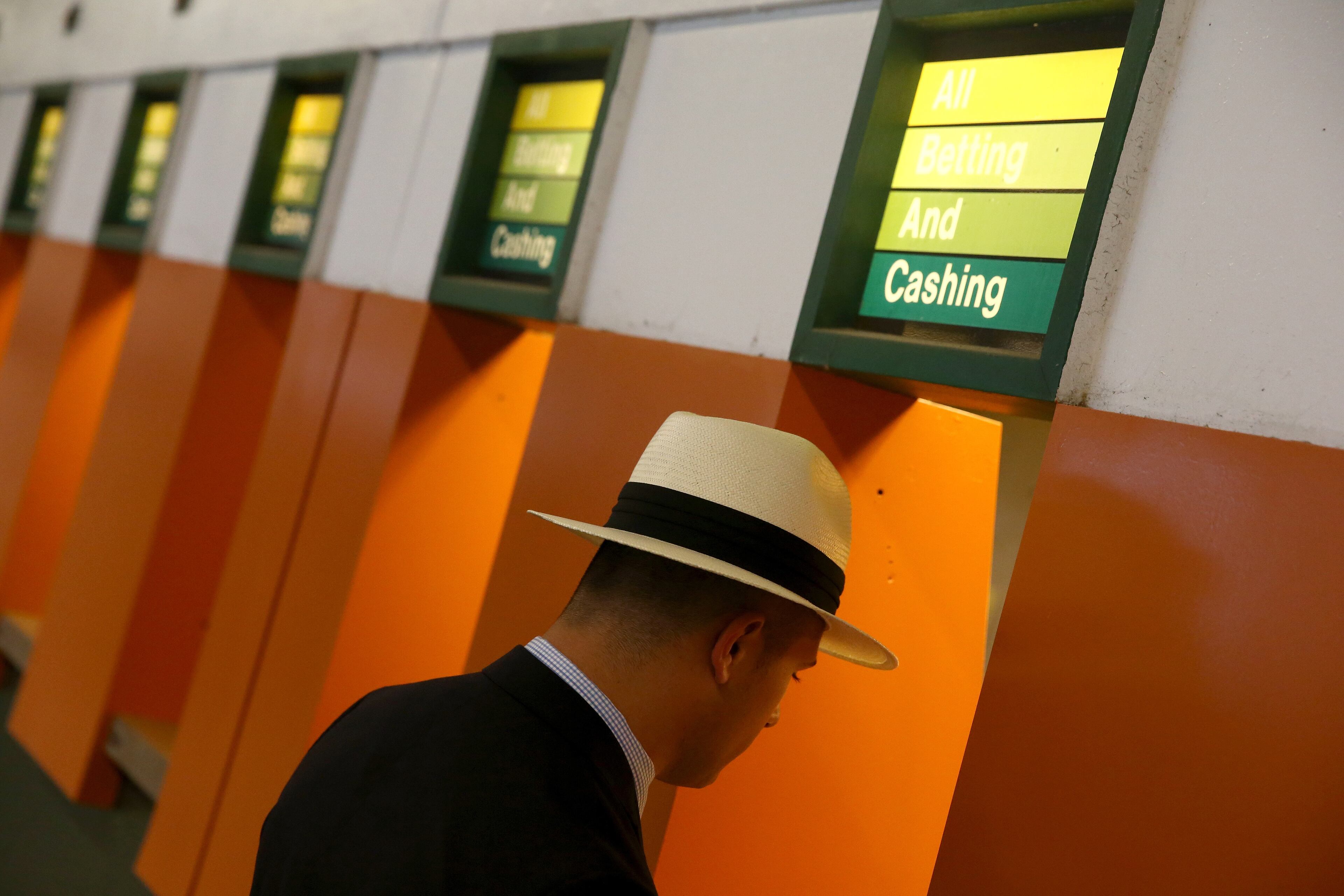 ELMONT, NY - JUNE 06: A race fan stands in front of a betting windows during the 147th running of the Belmont Stakes at Belmont Park on June 6, 2015 in Elmont, New York. (Photo by Streeter Lecka/Getty Images)