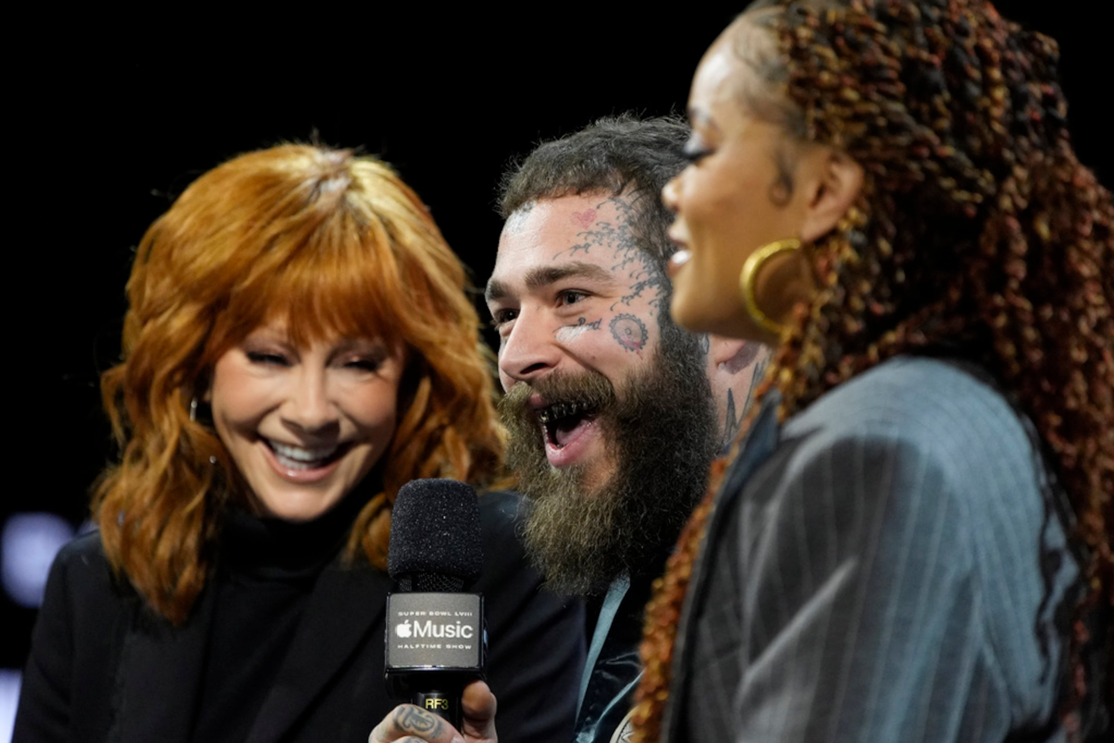 From left, Reba McEntire, Post Malone and Andra Day attend a news conference ahead of the Super Bowl 58 NFL football game Thursday, Feb. 8, 2024, in Las Vegas. (AP Photo/John Locher)