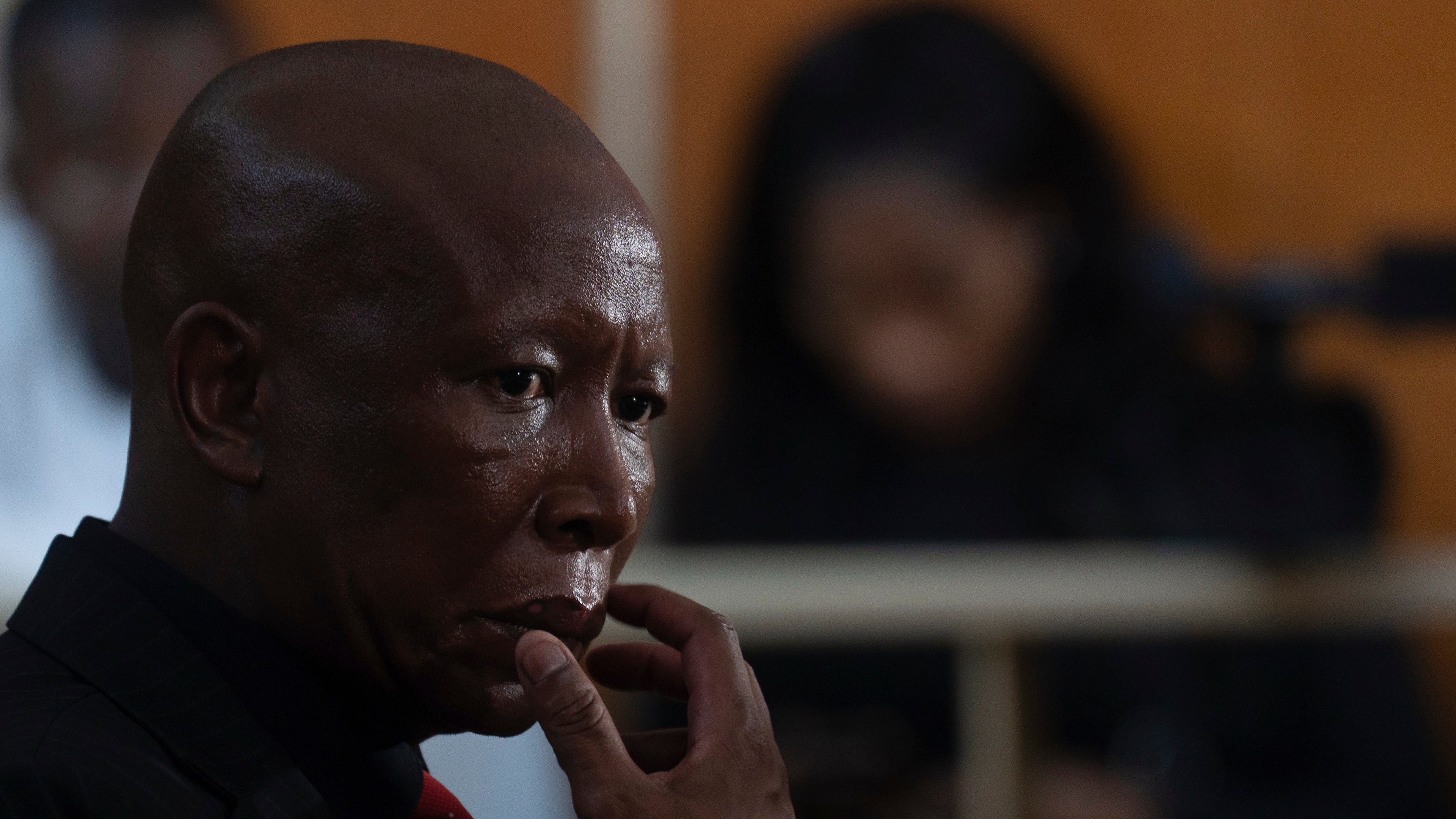 Julius Malema, leader of the Economic Freedom Fighters party, sits in a courtroom during sentencing for firing a rifle at a political rally, in East London, South Africa, Thursday, April 16, 2026. (AP Photo)