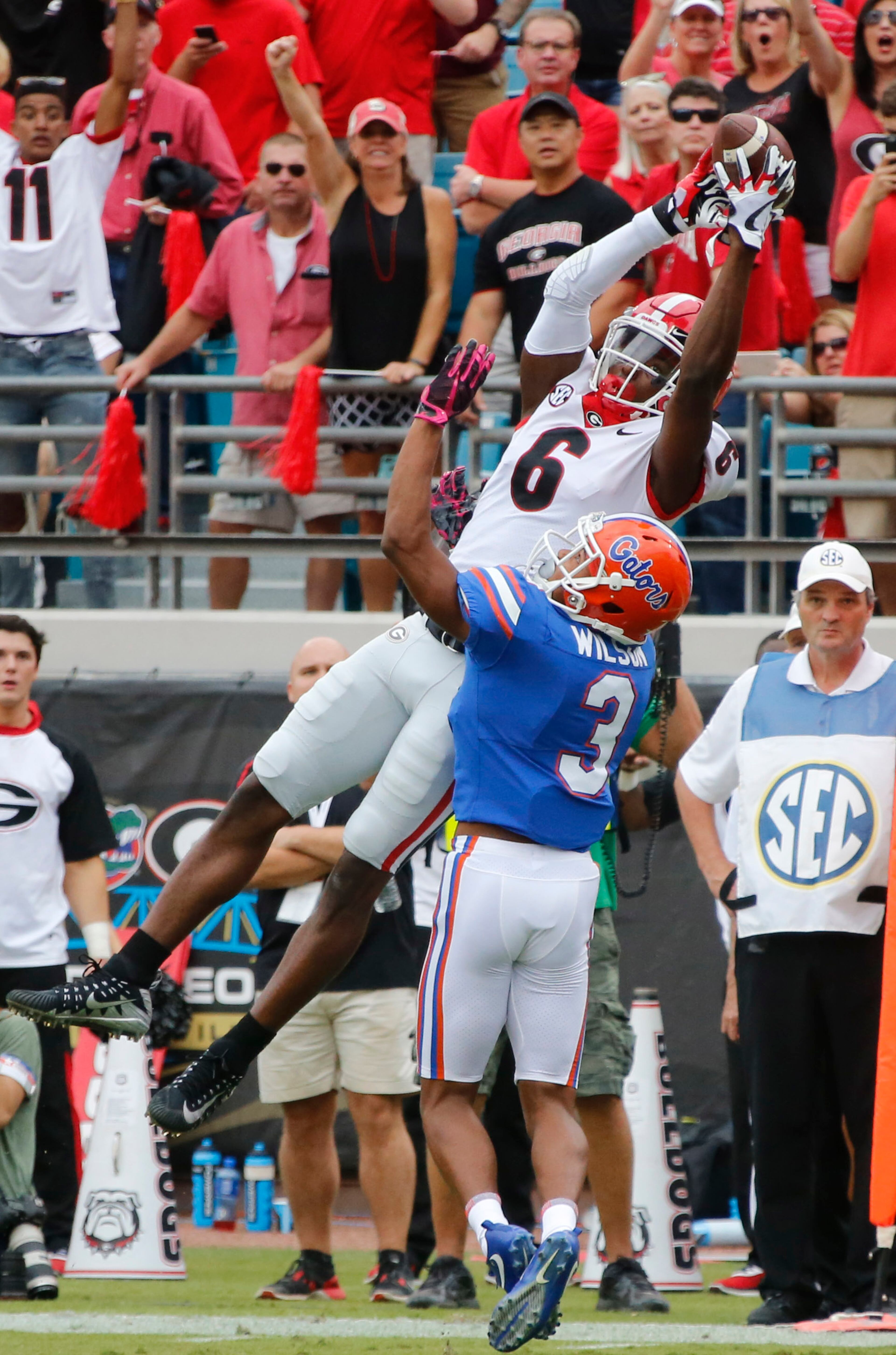 10/28/17 - Jacksonville, FL - Georgia Bulldogs wide receiver Javon Wims (6) goes hight to score one of three TDs in the first quarter. NCAA football game between Georgia and Florida at EverBank Field in Jacksonville. BOB ANDRES /BANDRES@AJC.COM