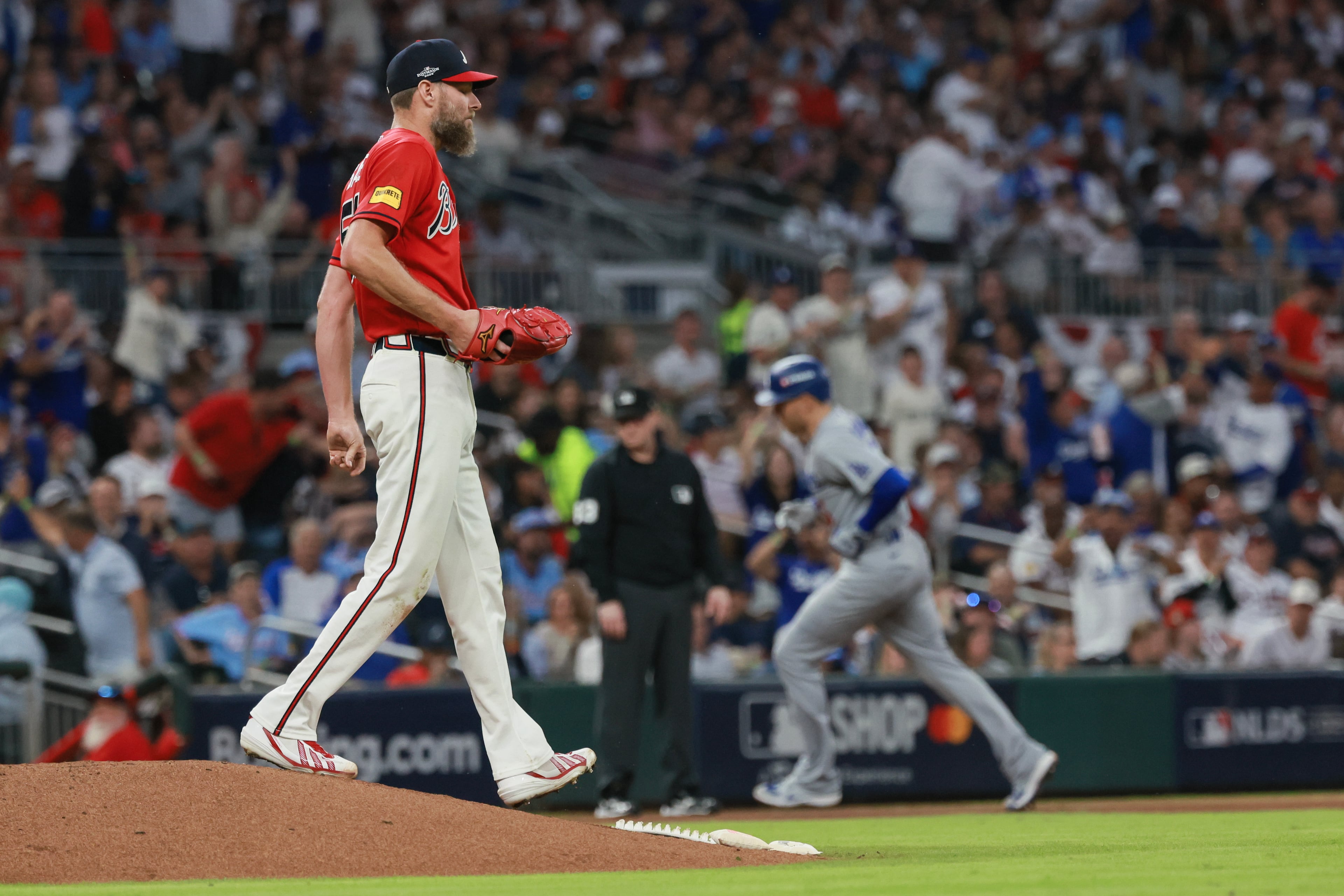 Atlanta Braves pitcher Chris Sale (51) walks off the mound after giving up a solo home run to Los Angeles Dodgers first baseman Freddie Freeman, right, during the fourth inning of Game 3 of the MLB National League Division Series between the Atlanta Braves and the Los Angeles Dodgers, Tuesday, Oct. 6, 2026, in Atlanta. (Jason Getz/AJC)