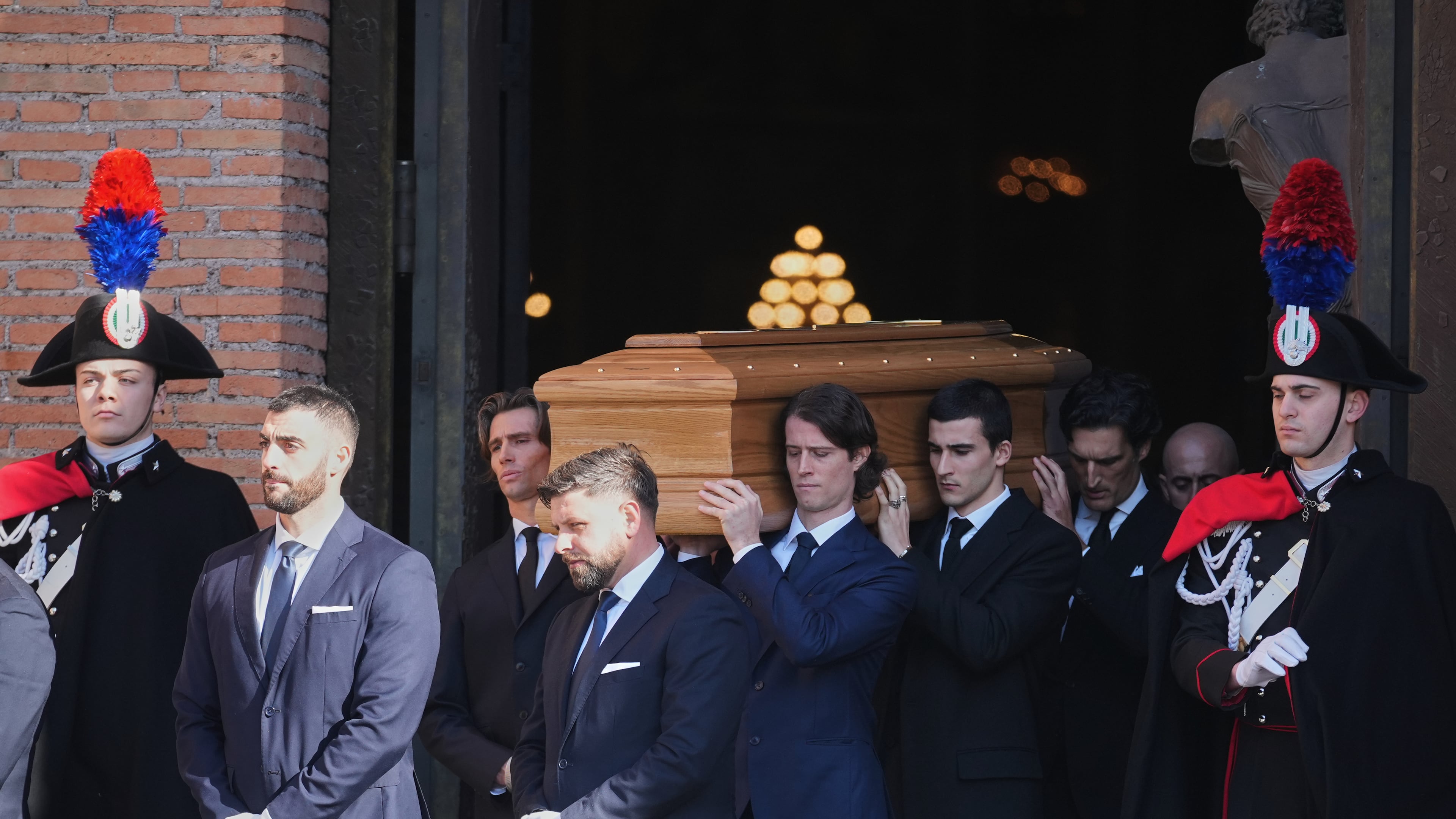 The casket of fashion designer Valentino Garavani leaves the St. Mary of Angels Basilica at the end of his funeral, in Rome, Friday, Jan. 23, 2026. (AP Photo/Andrew Medichini)