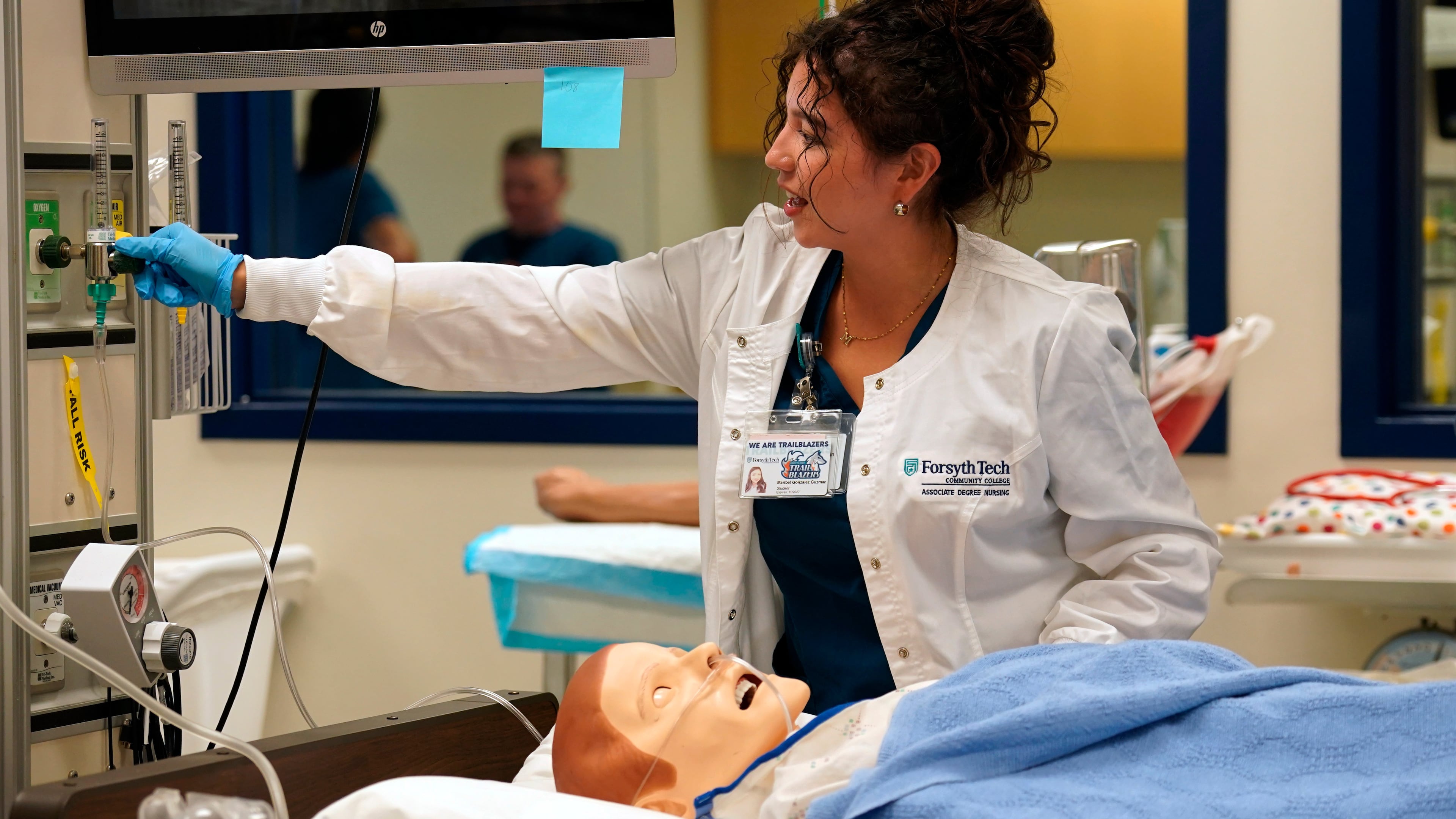 Nursing student Maribel Gonzalez Guzman checks a patient manikin in the simulation lab at Forsyth Technical Community College in Winston-Salem, N.C., Thursday, Aug. 20, 2026. (AP Photo/Chuck Burton)