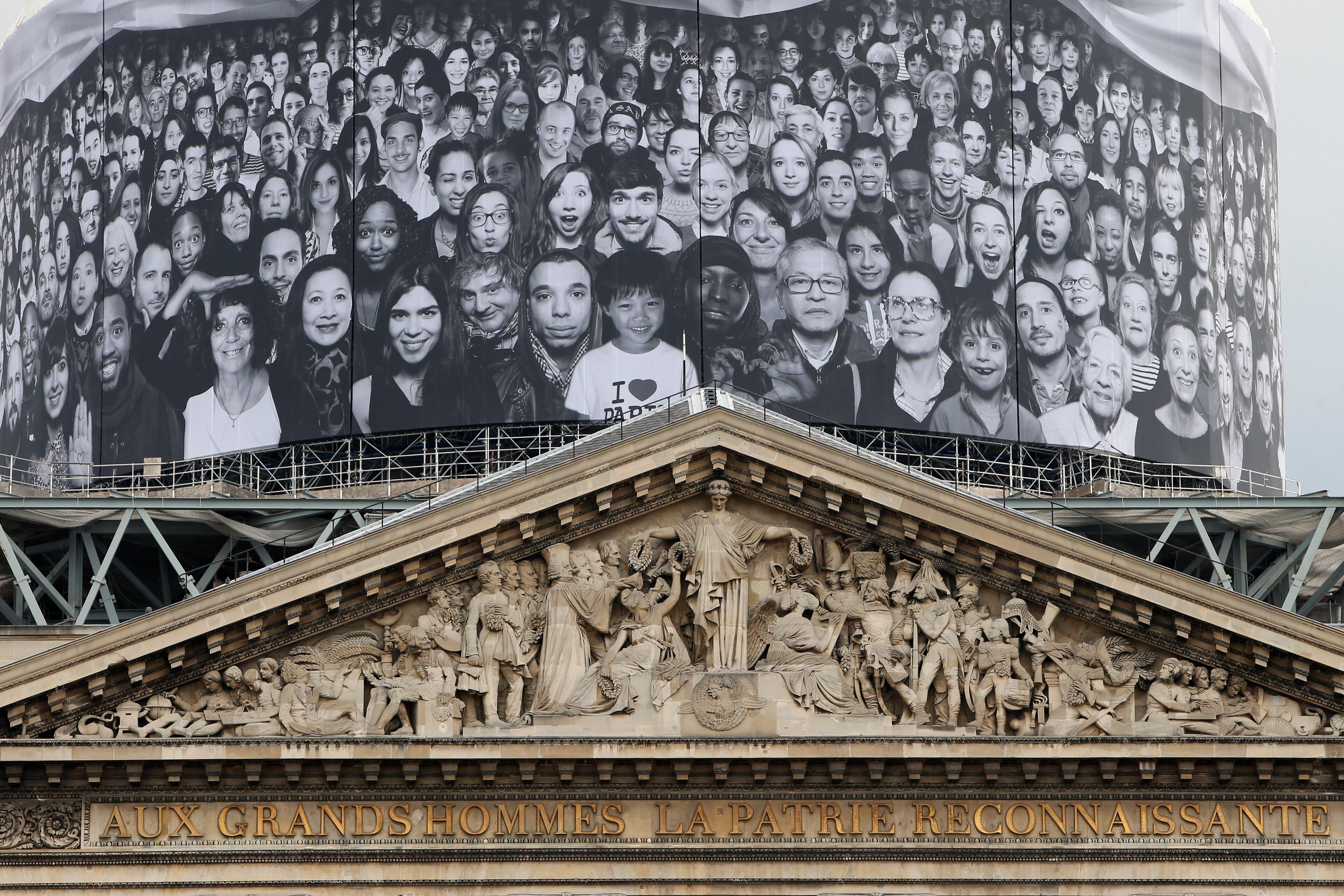 A giant photos of portraits by French street artist and photographer JR decorates the dome of the Pantheon during the presentation of his creation in Paris, Tuesday, June 3, 2014. French Government named JR to decorate with portraits the dome of Paris' Pantheon, that is the final resting place for 72 of France's renowned men, and just one woman, as the monument is undergoing a 2 year renovation. (AP Photo/Francois Mori)