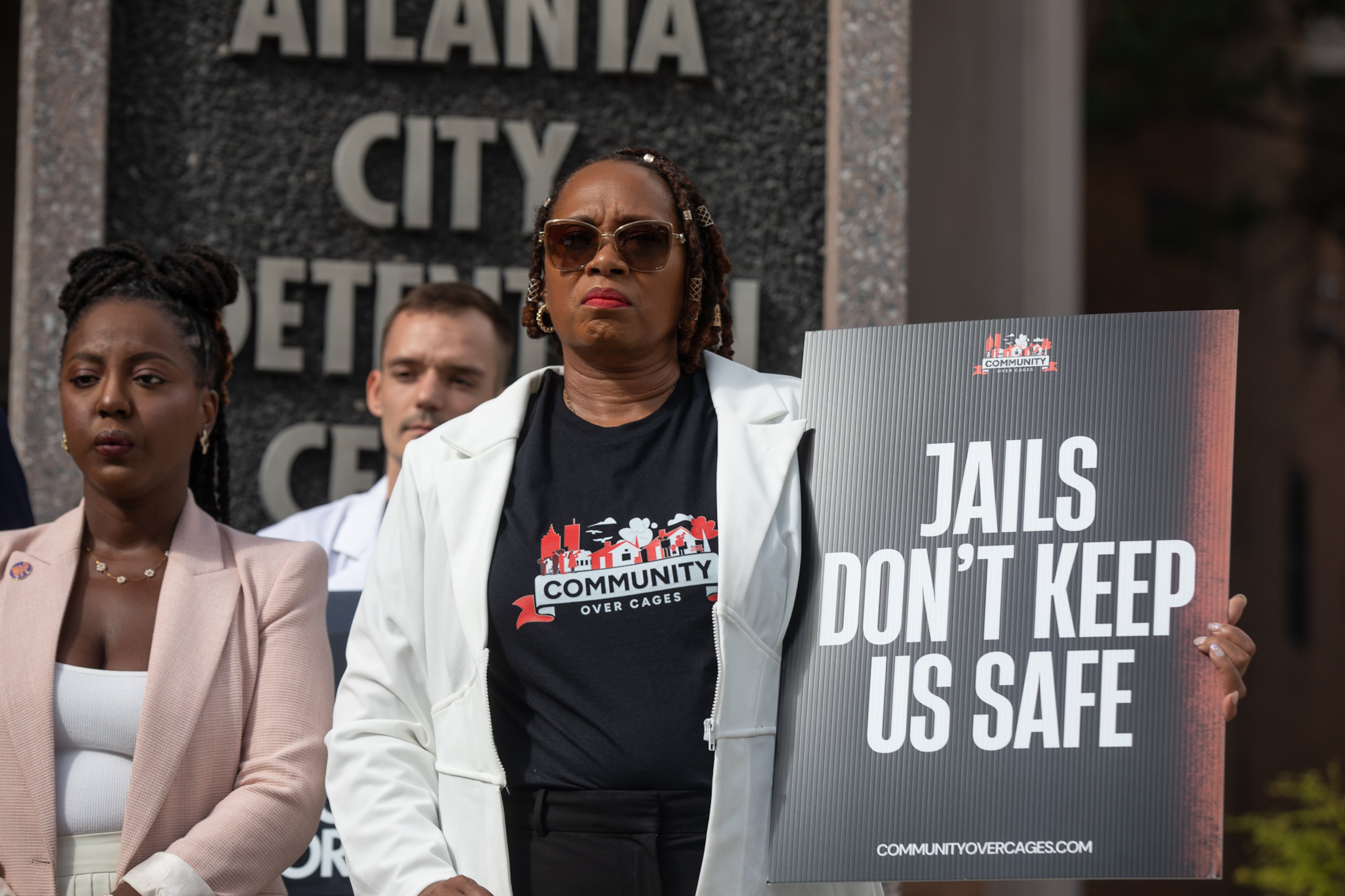 Roberta Meyers, with the Legal Action Center, joins advocates outside of the Atlanta City Detention Center on Aug. 13, 2025, to call for city officials to begin planning the withdrawal of Fulton County inmates from the jail. (Riley Bunch/AJC)