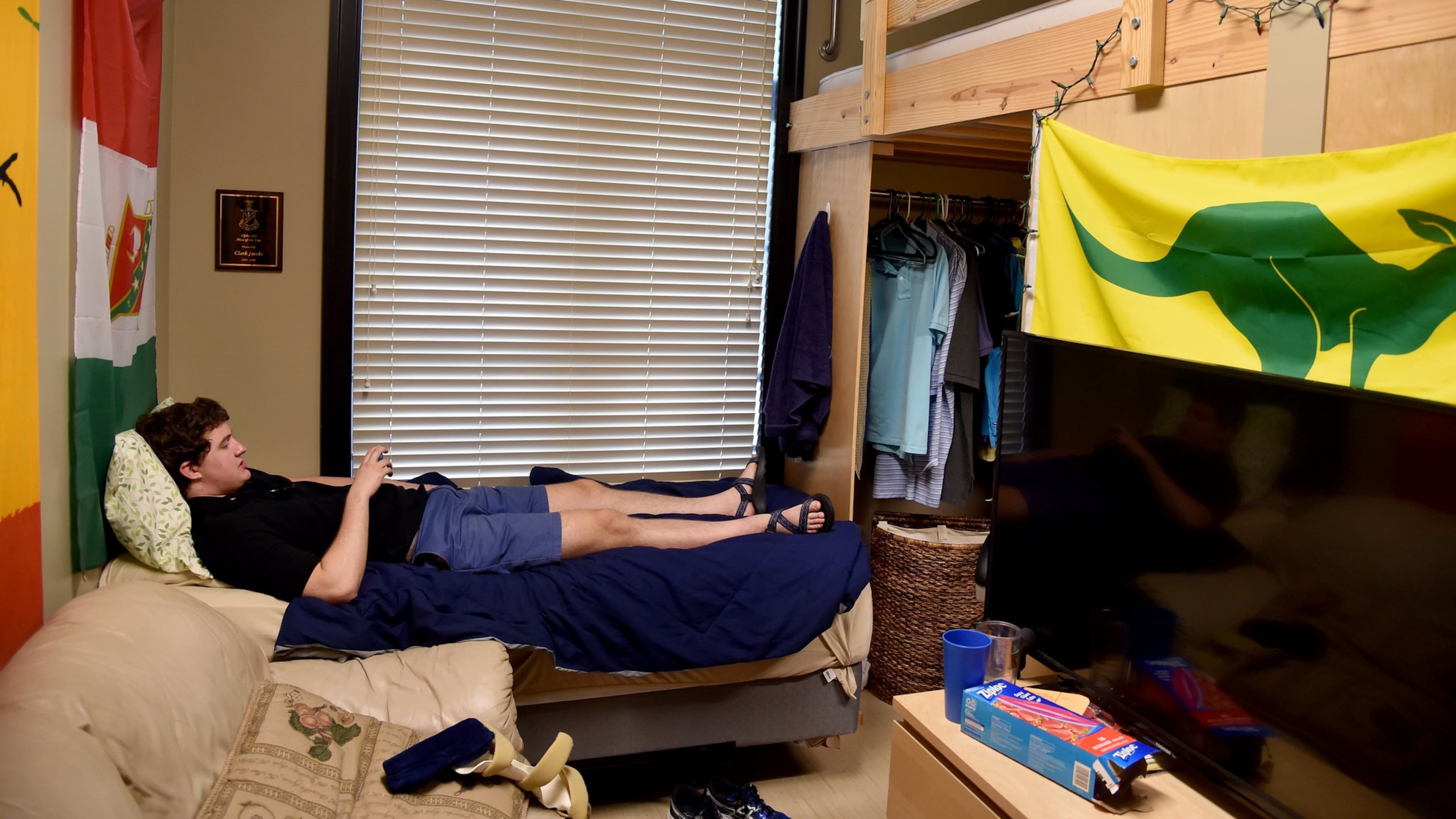 Georgia Tech student Clark Jacobs hangs out in his room at the Kappa Sigma fraternity house on Thursday, Aug. 25, 2016. Jacobs is back in school after cracking his skull in January 2015, when he fell out of his bunk bed. The mechanical engineering student isn’t taking any chances and now sleeps on a bed below his assigned loft. BRANT SANDERLIN/BSANDERLIN@AJC.COM