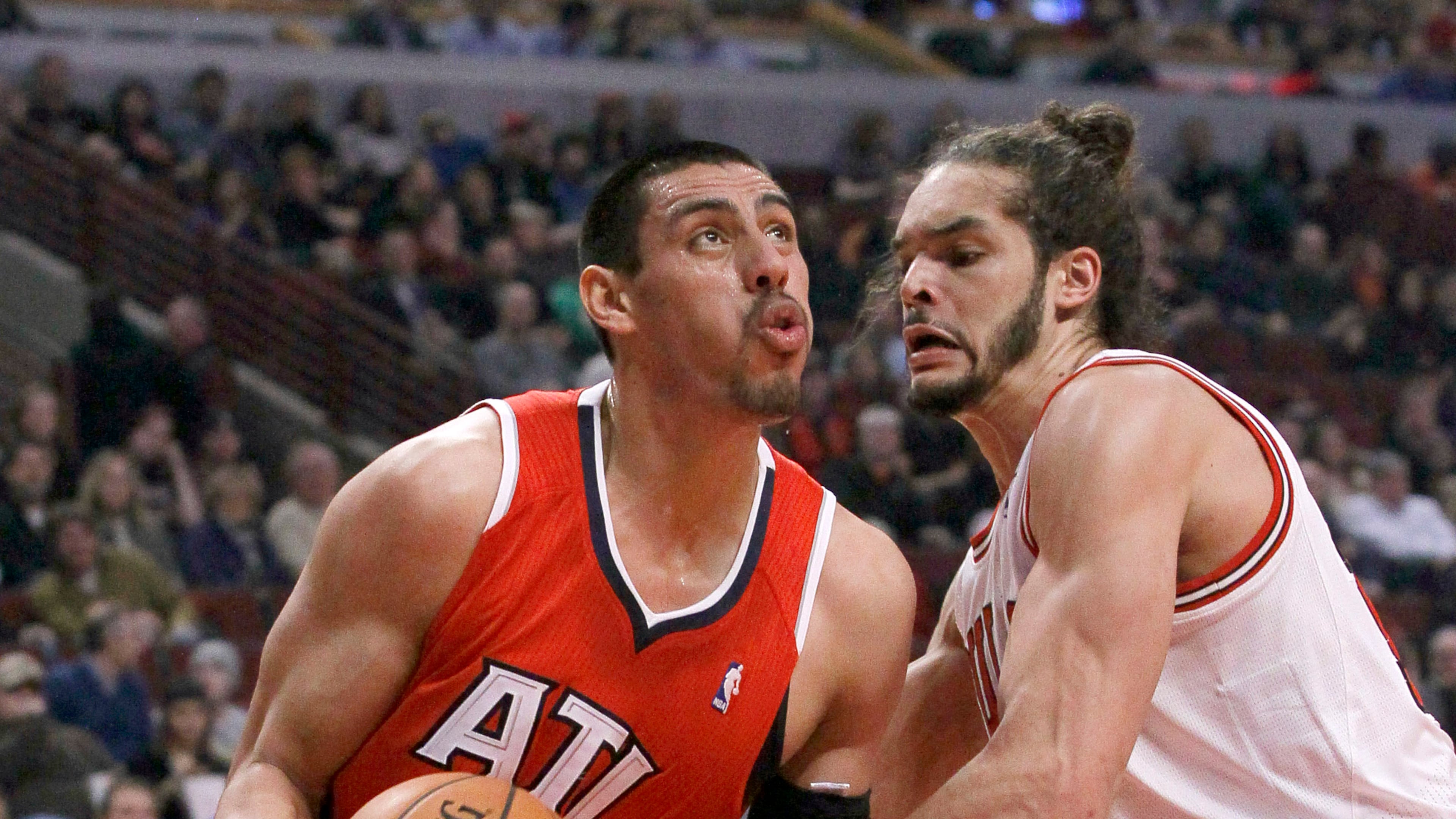 Atlanta Hawks forward Gustavo Ayon (14) looks to the basket as Chicago Bulls center Joakim Noah (13) defends during the first half of an NBA basketball game Tuesday, Feb. 11, 2014, in Chicago. (AP Photo/Charles Rex Arbogast)
