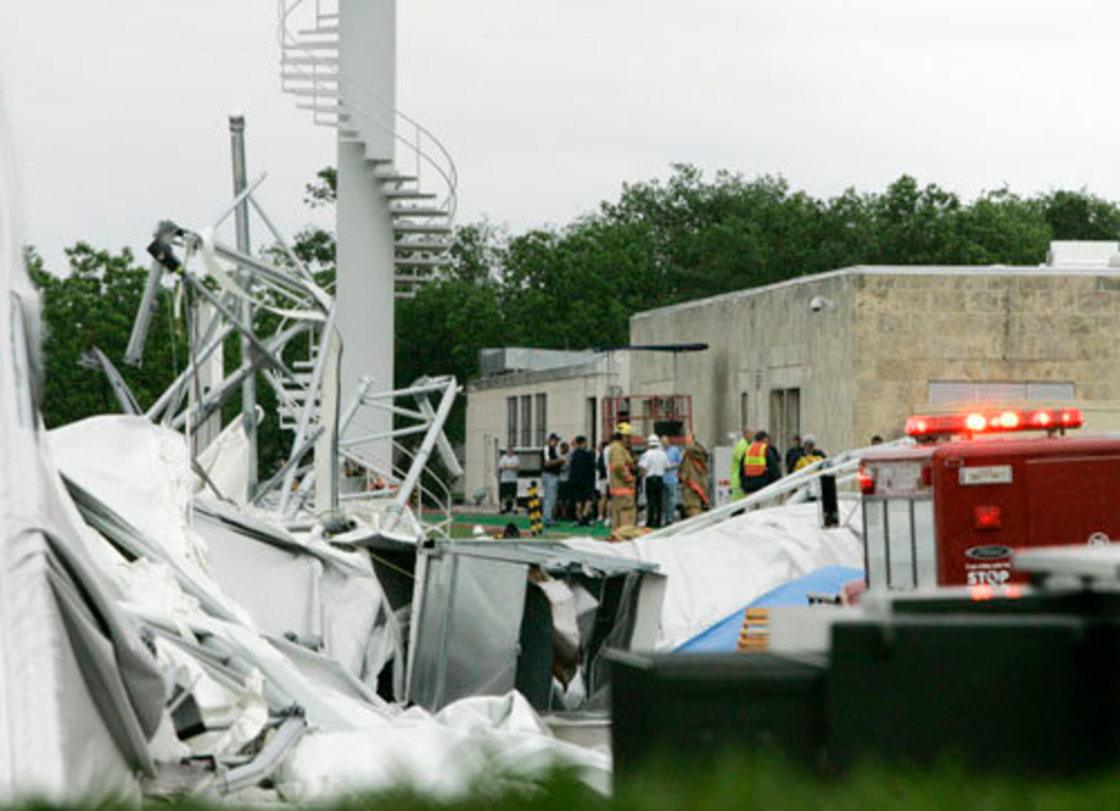 Emergency personnel stand near the Dallas Cowboys practice field structure that collapsed.