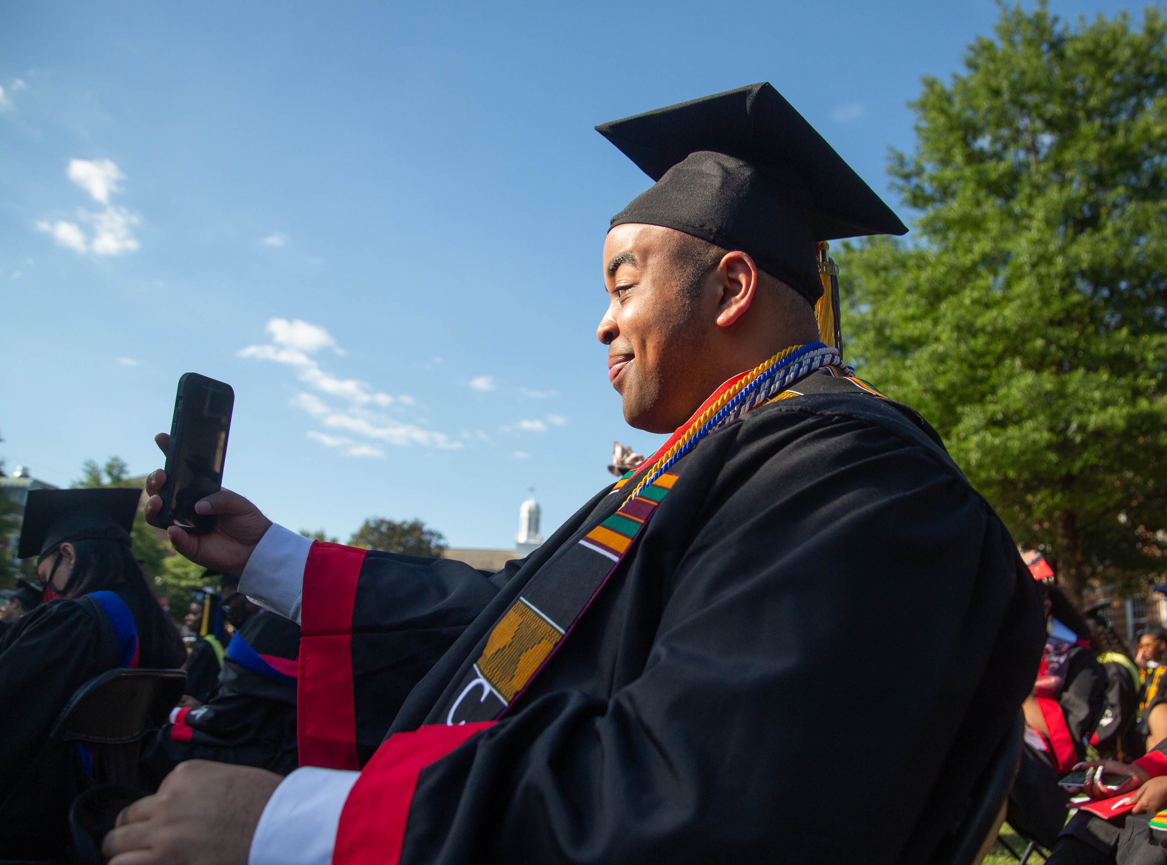 A 2020 Clark Atlanta Univesrity graduate takes a selfie during the Saturday ceremony at the Harkness Hall Quadrangle in Atlanta on May 15, 2021. The 2020 ceremony was postponed because of the COVID-19 pandemic. The class of 2021 also held its ceremony Saturday. (Photo: Steve Schaefer for The Atlanta Journal-Constitution)