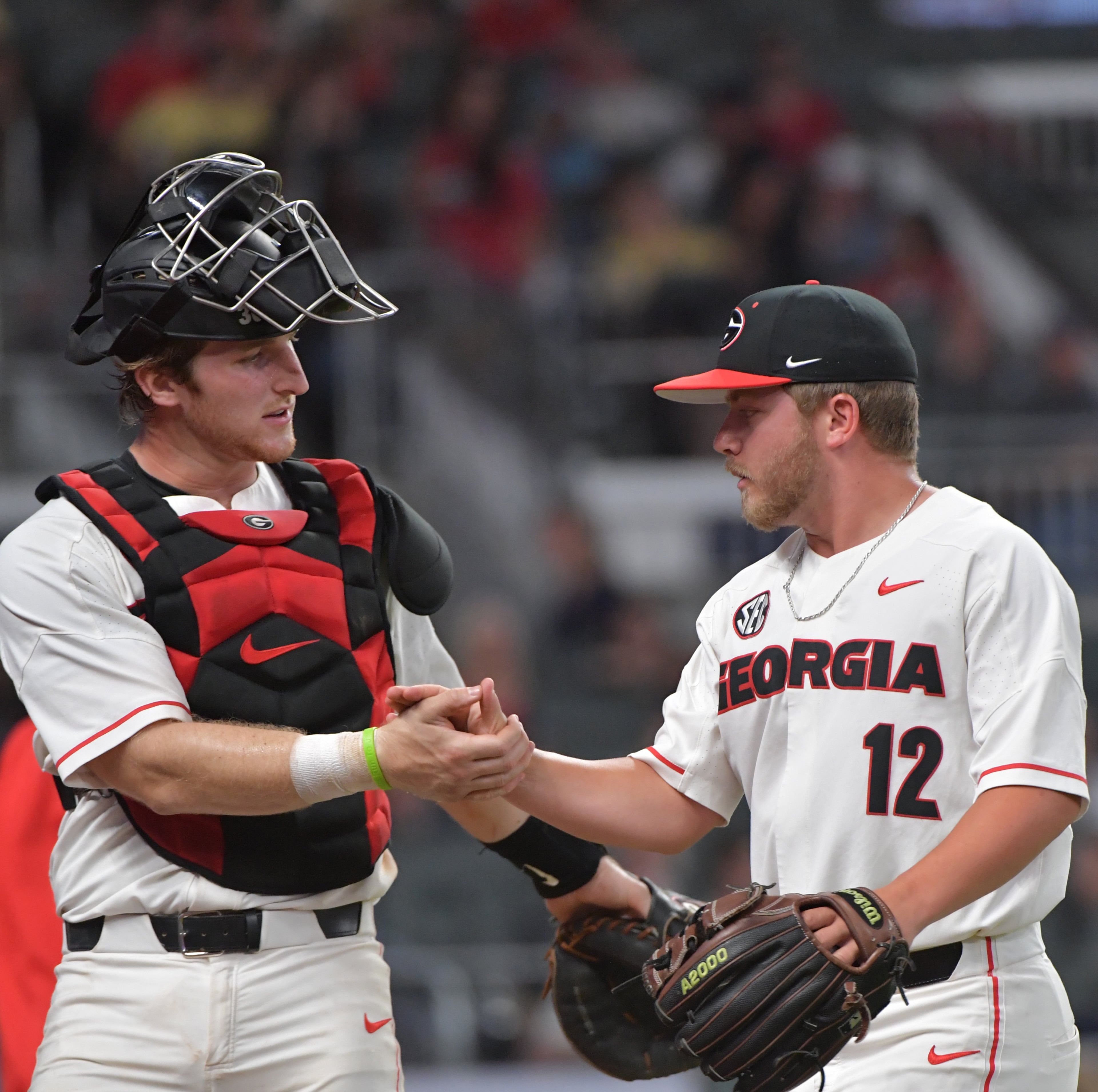 May 8, 2018 Atlanta - Georgia catcher Mason Meadows (30) and pitcher Zac Kristofak (12) celebrate in the 8th inning in the 16th annual Farmview Market Spring Classic during a NCAA college baseball game at SunTrust Park on Tuesday, May 8, 2018. Georgia won 3 - 1 over the Georgia Tech. HYOSUB SHIN / HSHIN@AJC.COM
