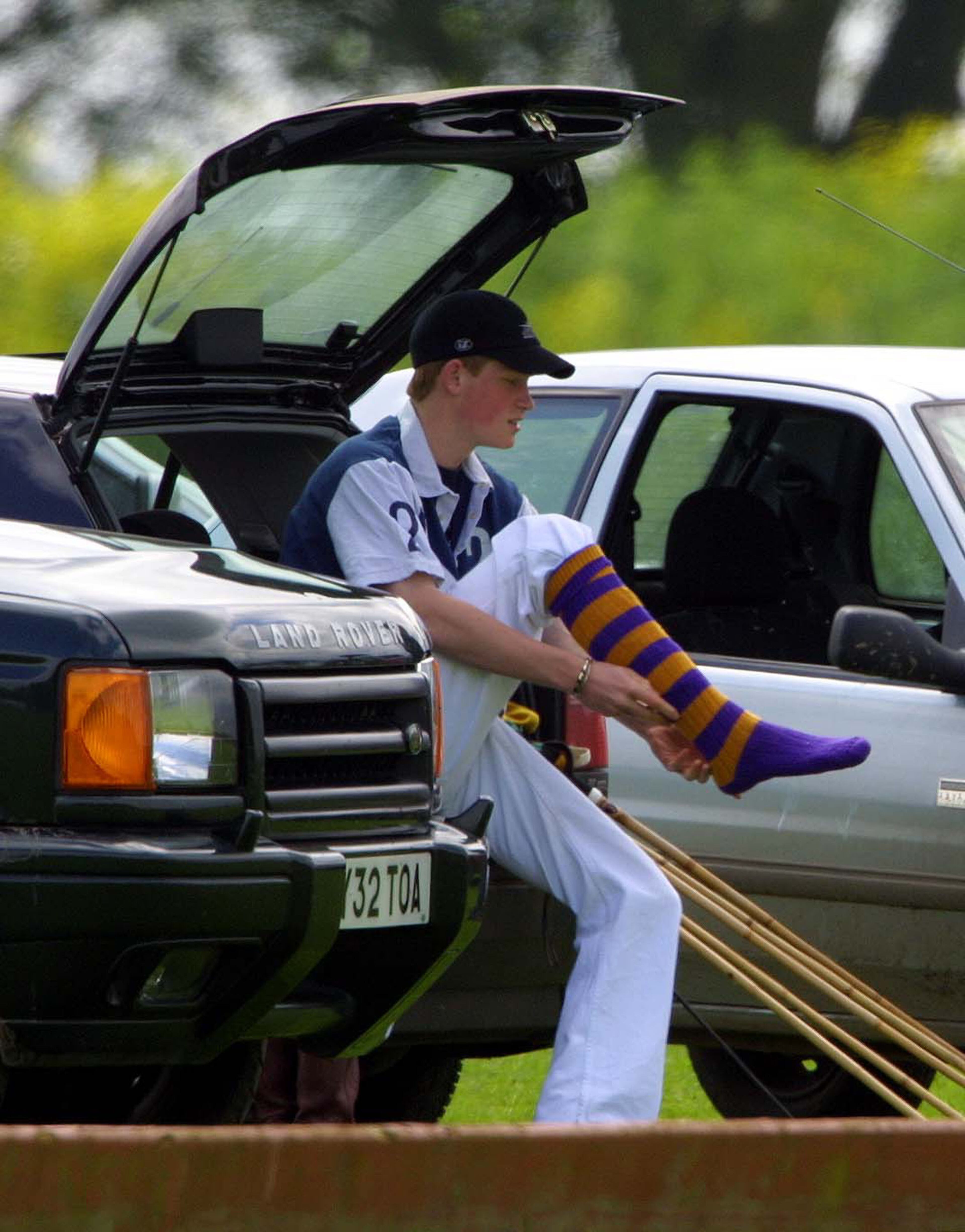 Britain's Prince Harry gets ready to play polo June 8, 2002, in the Chakravarty Cup at Beaufort Polo Club, United Kingdom.