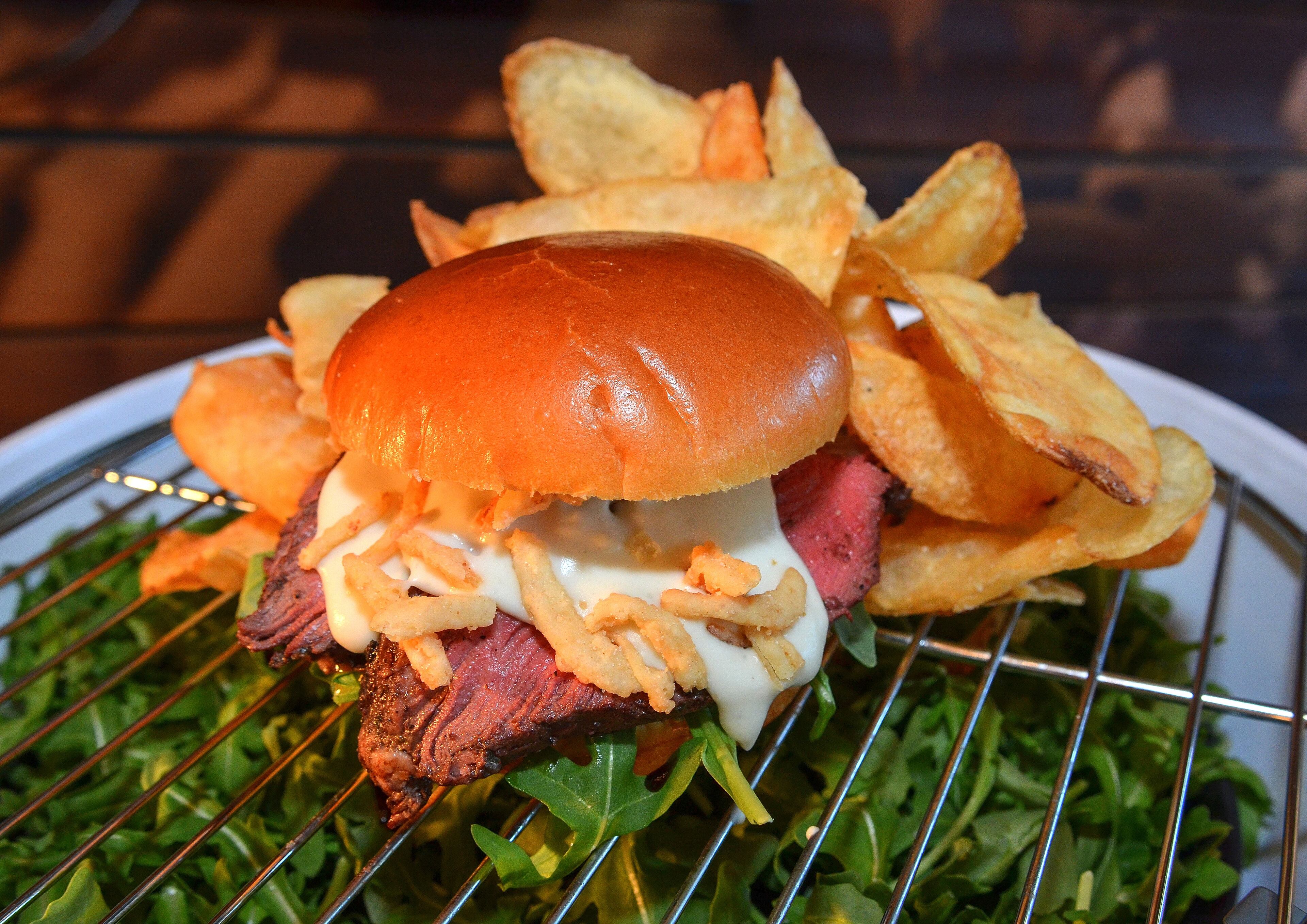 The Best Darn Steak Sandwich in Baseball (section 112). Featuring sliced herbed beef tenderloin served on a fresh brioche roll with balsamic glazed arugula, roasted Portobello, crunchy fried onion, and creamy blue cheese sauce. Served with house-made truffle chips. $23.